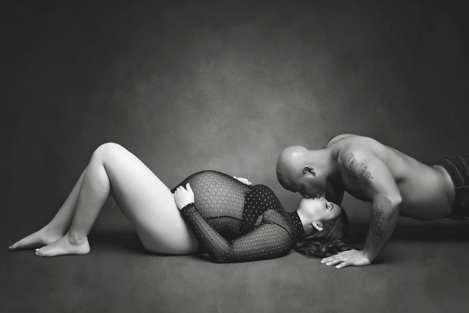 Black and white boudoir photography series with minimalist poses on dark backdrop.