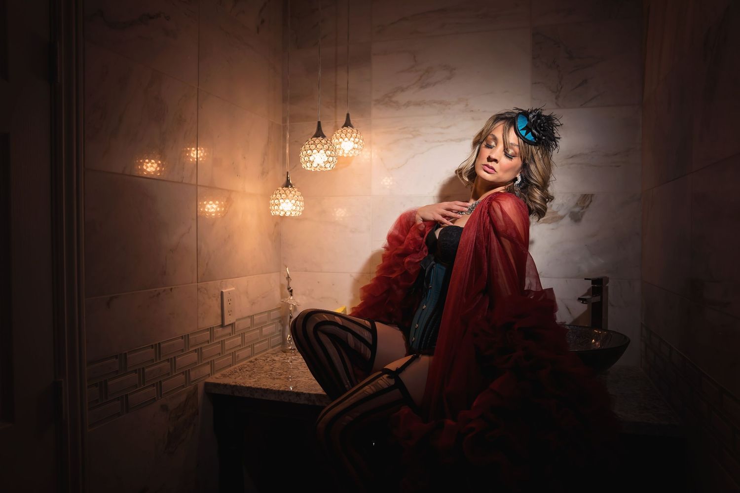Atmospheric boudoir scene with red fabric and vintage pendant lights.