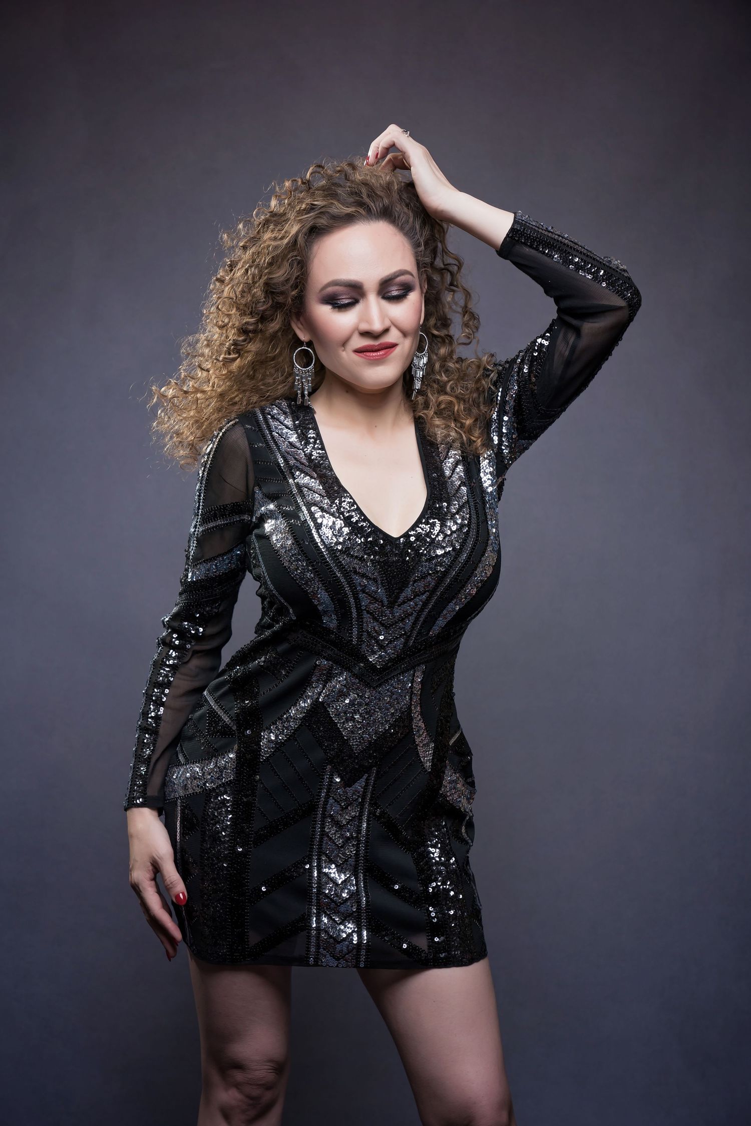 Glittering black sequined blazer dress styled for a fashion photography session.