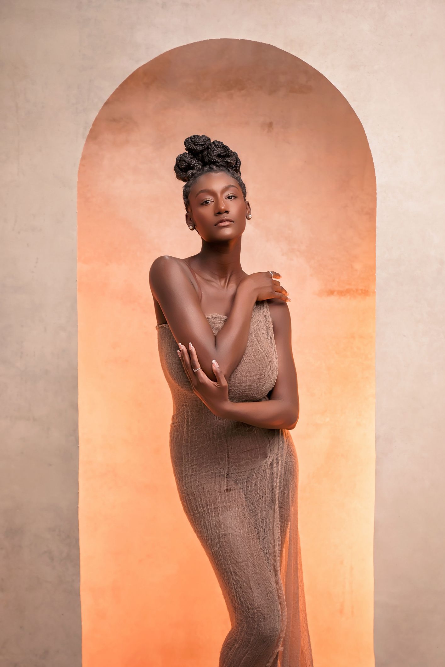 Artistic studio portraits featuring dynamic poses and warm lighting effects.