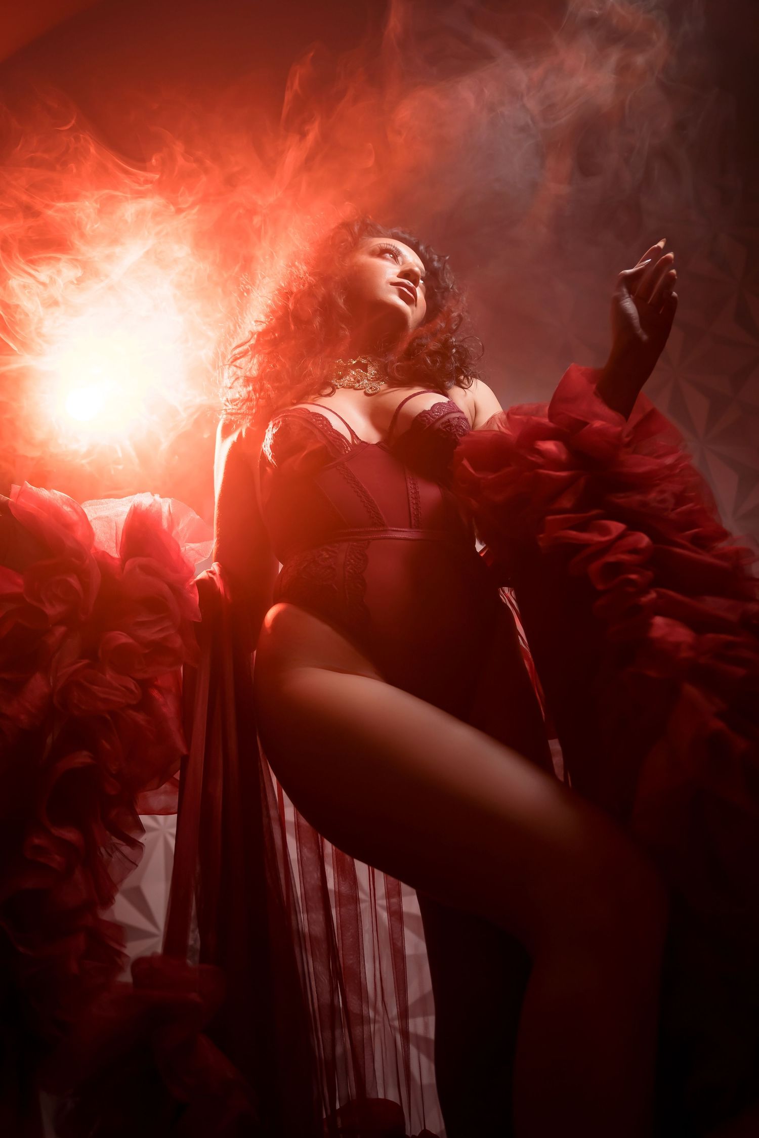 Dramatic silhouette photo with red smoke effects and dark shadows.