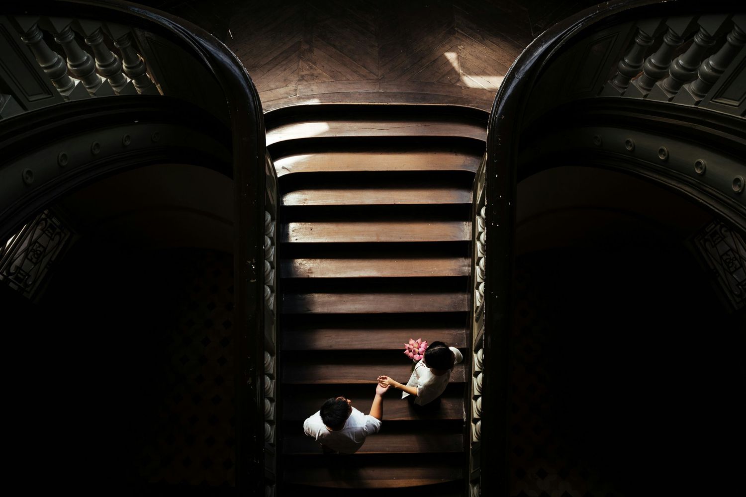 A series of seven black and white architectural photographs showing dramatic light and shadow patterns through blinds.