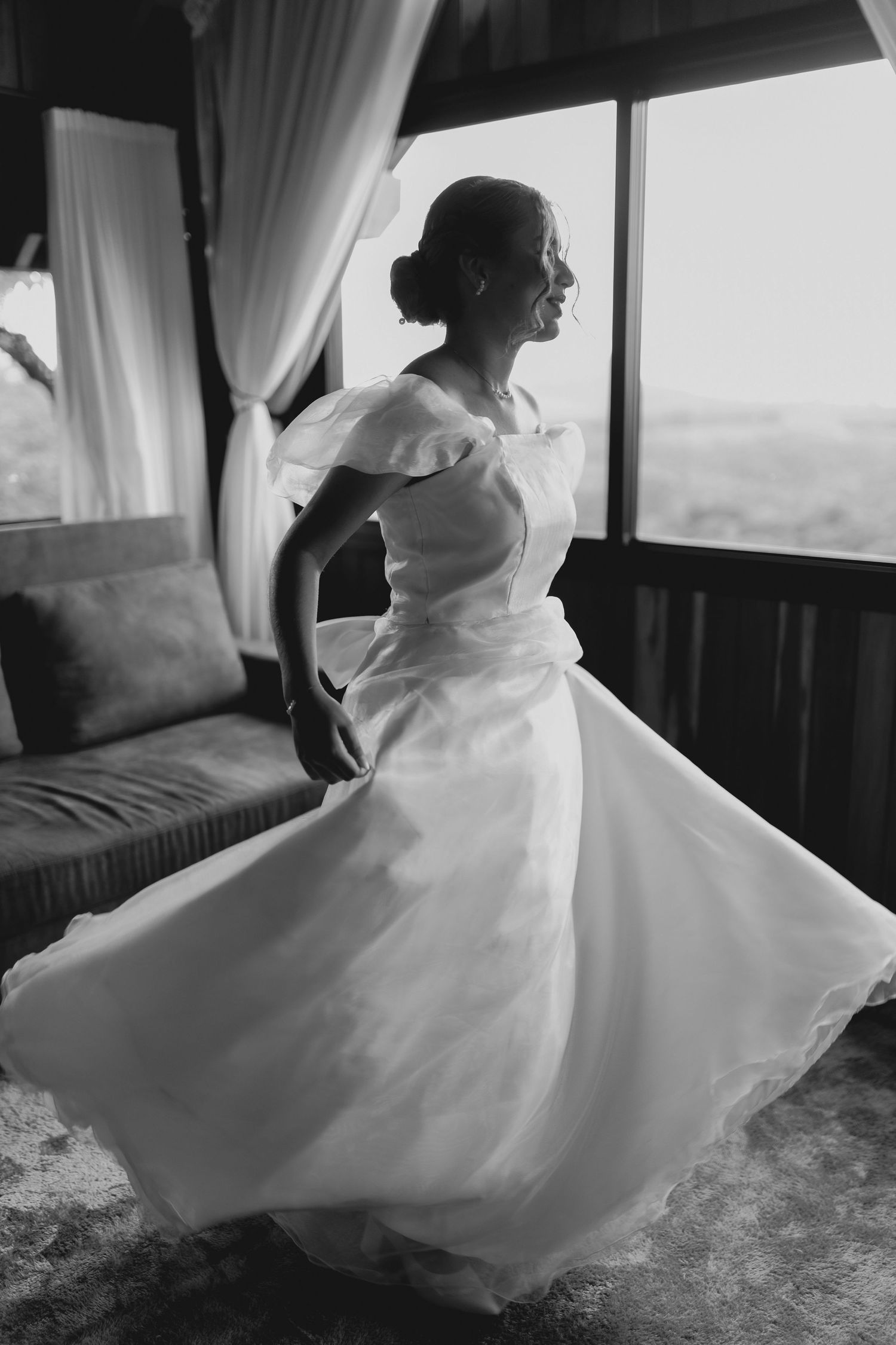 A black and white photo series shows a flowing white wedding dress in motion against dark interior backgrounds.