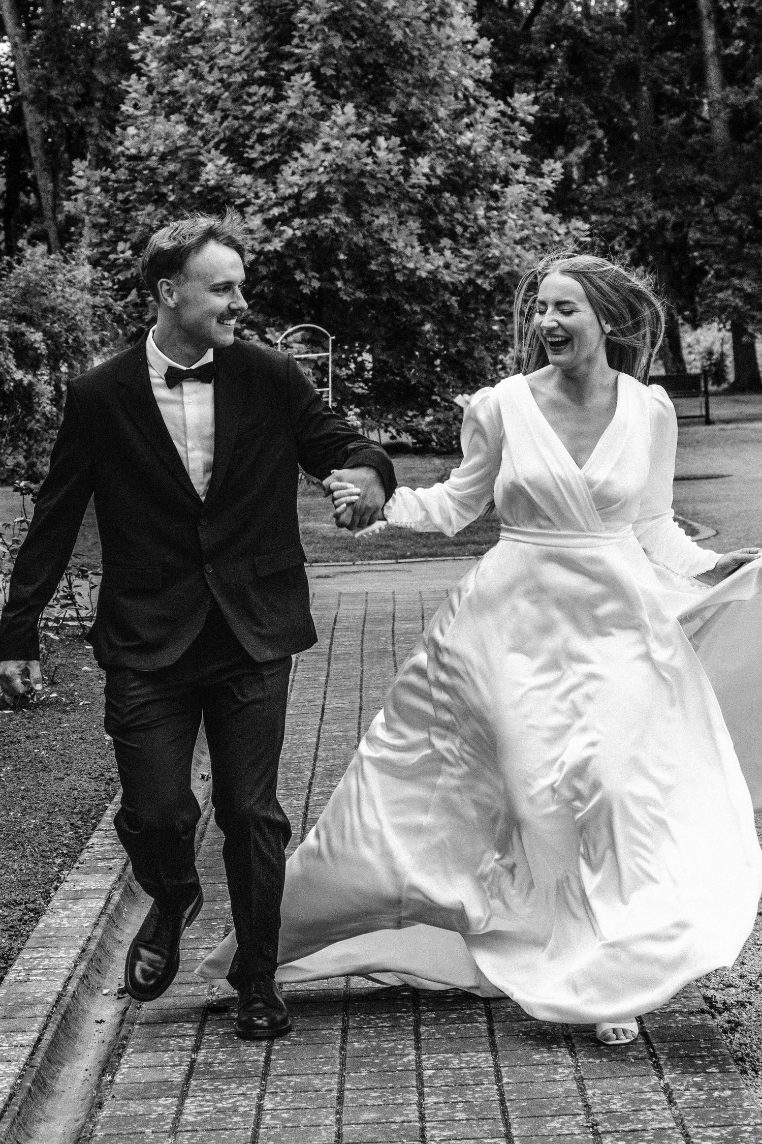 Black and white wedding photo sequence showing couple playfully sitting and interacting on wooden deck outdoors.