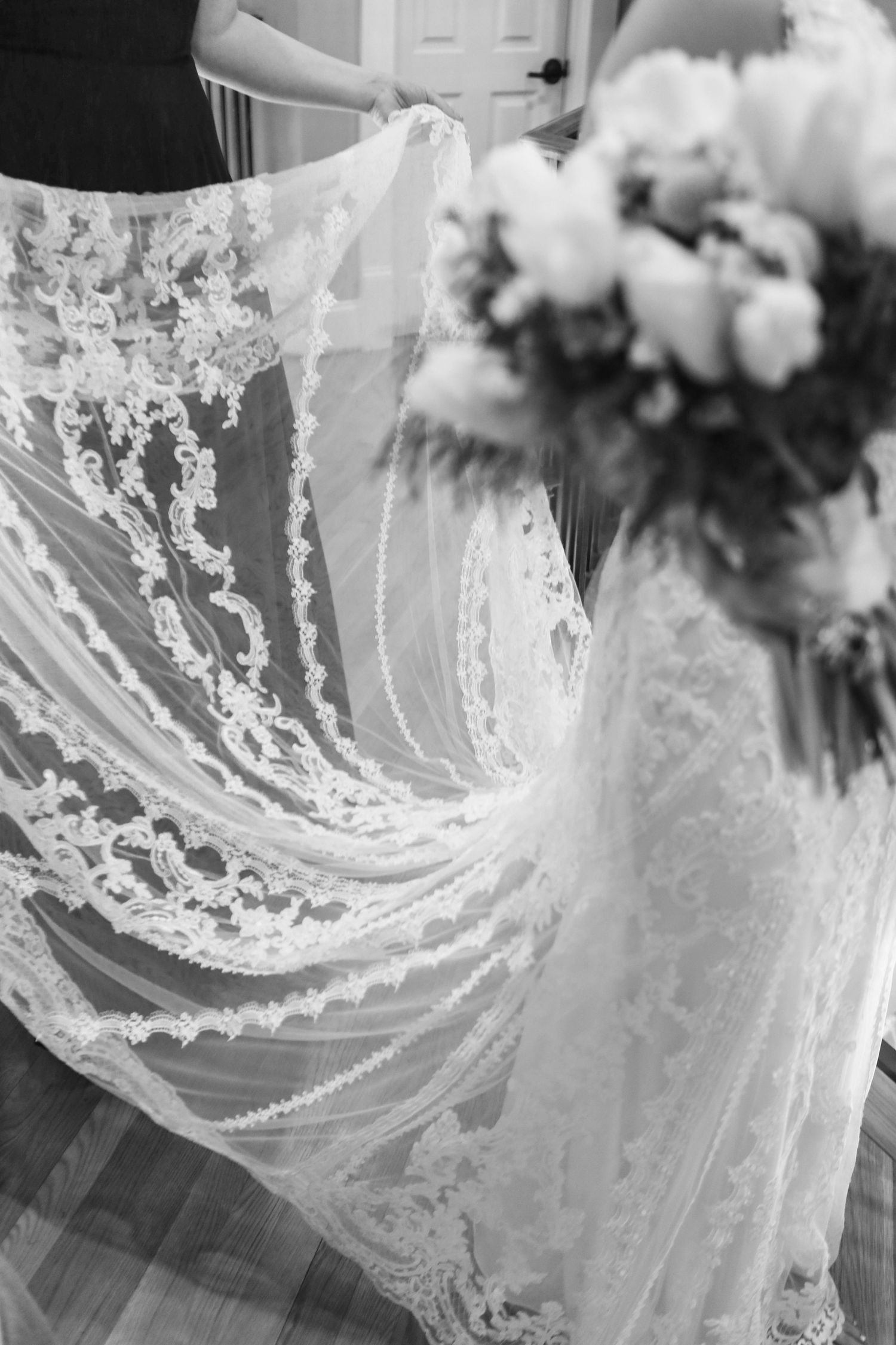 Close-up detail of intricate lace patterns on white wedding dress veil.