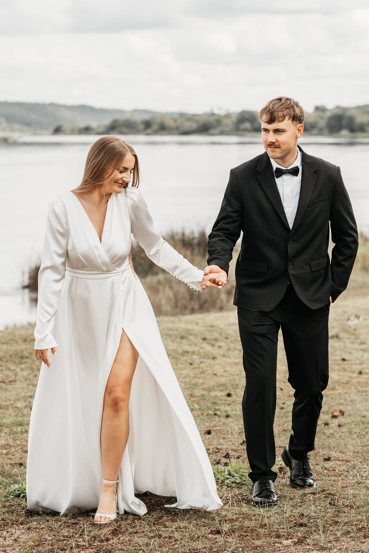 A bride in a white dress and groom in black suit walk together in a scenic outdoor setting, shown in multiple angles.