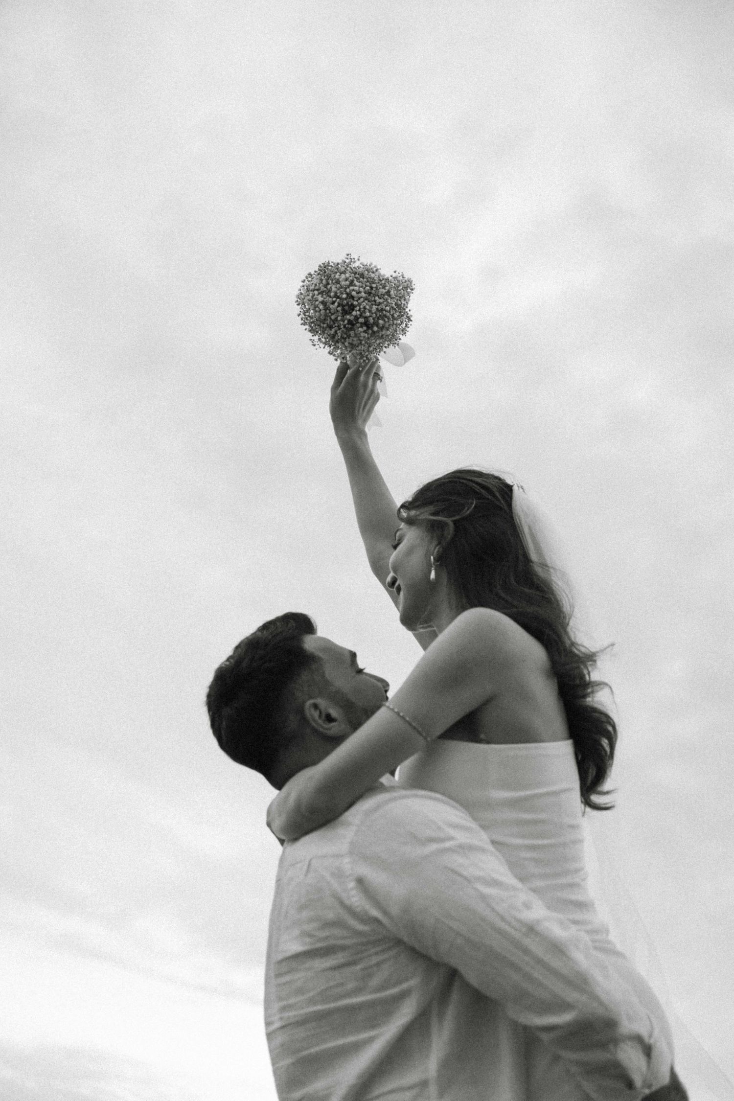 A romantic series of black and white photos showing a couple embracing and dancing together in bridal wear.