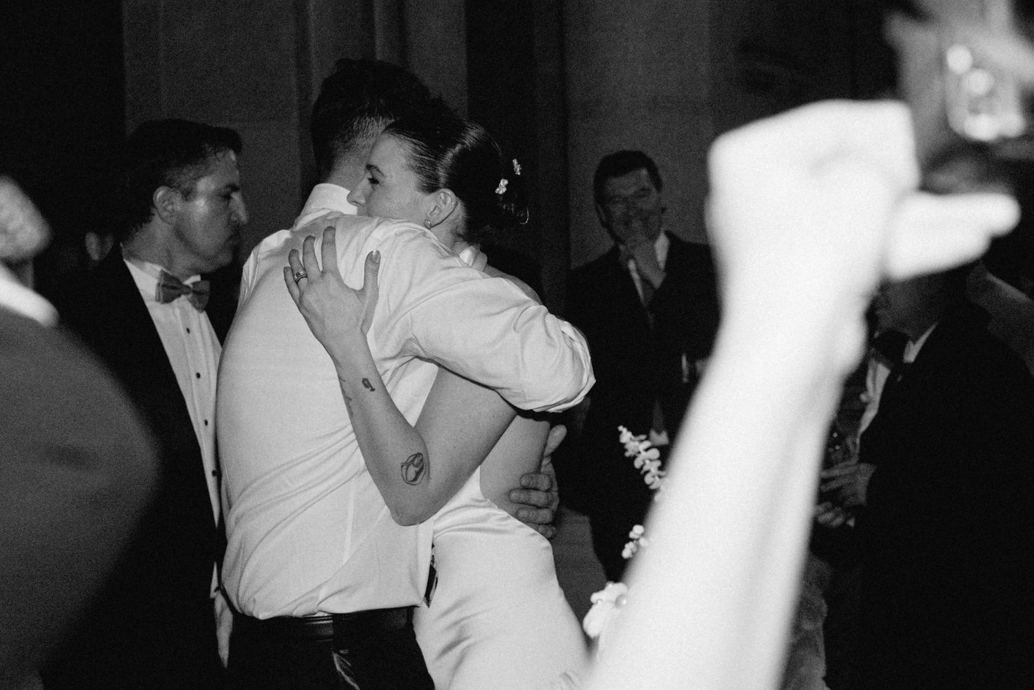 A black and white photo sequence showing dancing couples embracing during a formal celebration or dance event.