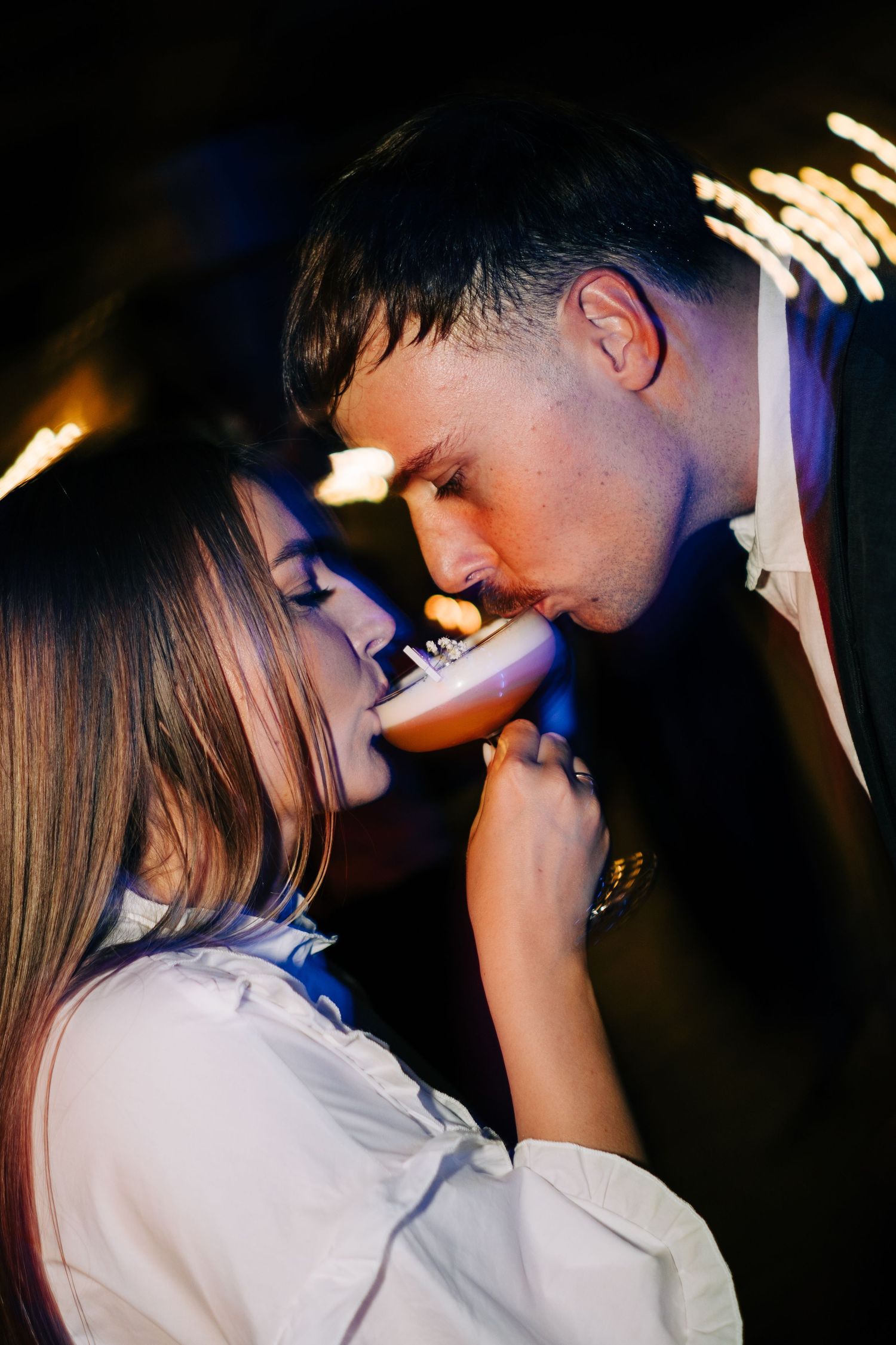Intimate dance photos of a couple under romantic lighting at their wedding reception.