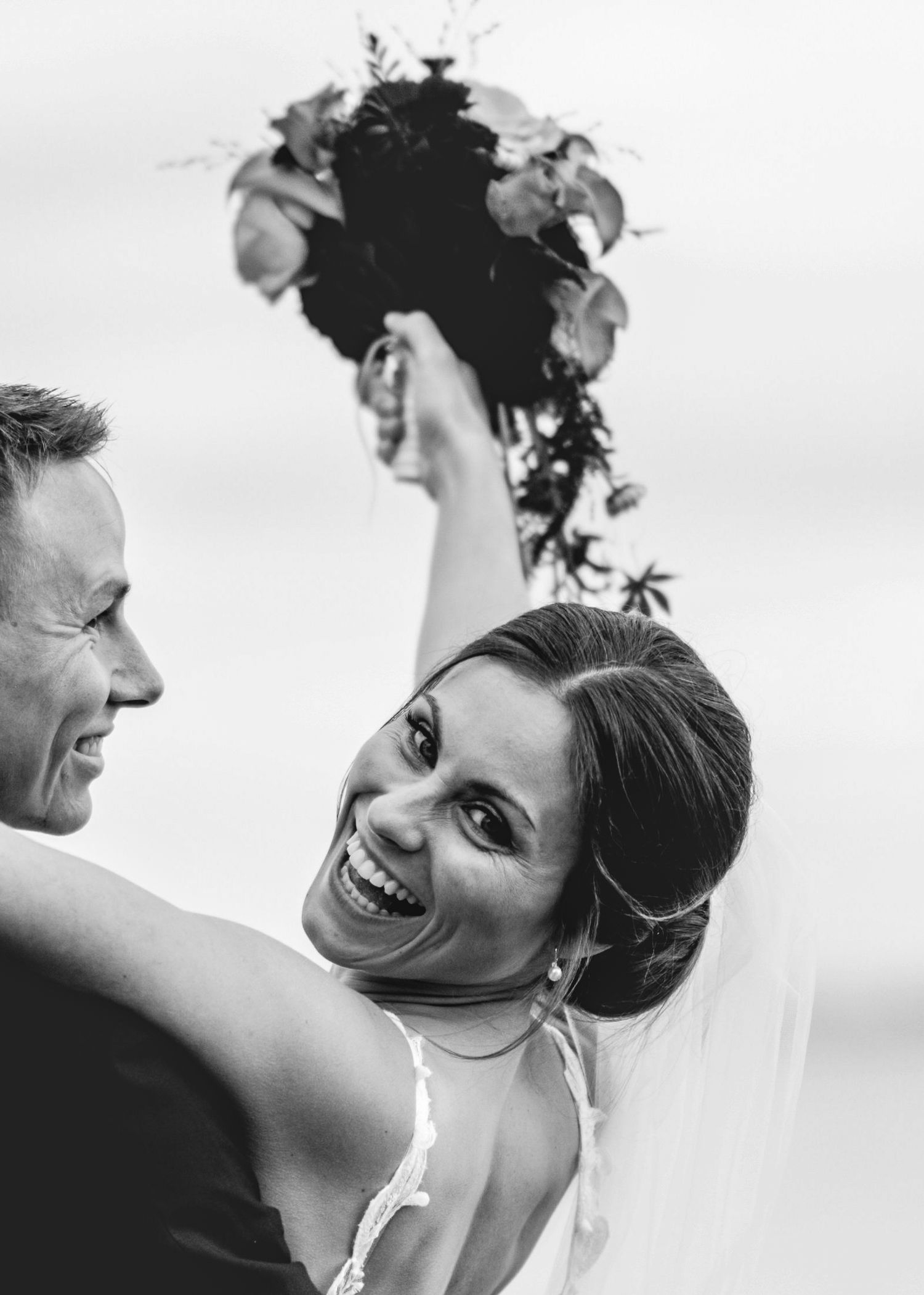 Black and white photo series showing candid moments of a couple laughing and interacting together.