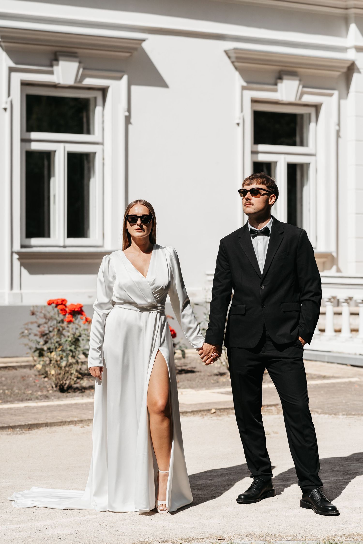 A series of wedding photos showing a couple in formal attire posing outside a white building.