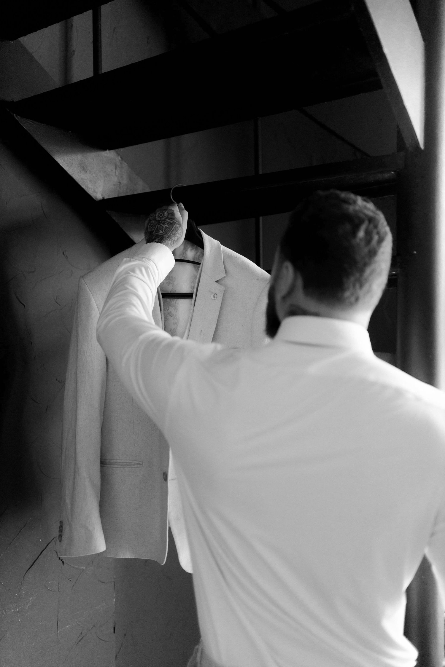 A series of black and white photographs showing someone in a white shirt viewed from behind in various poses.