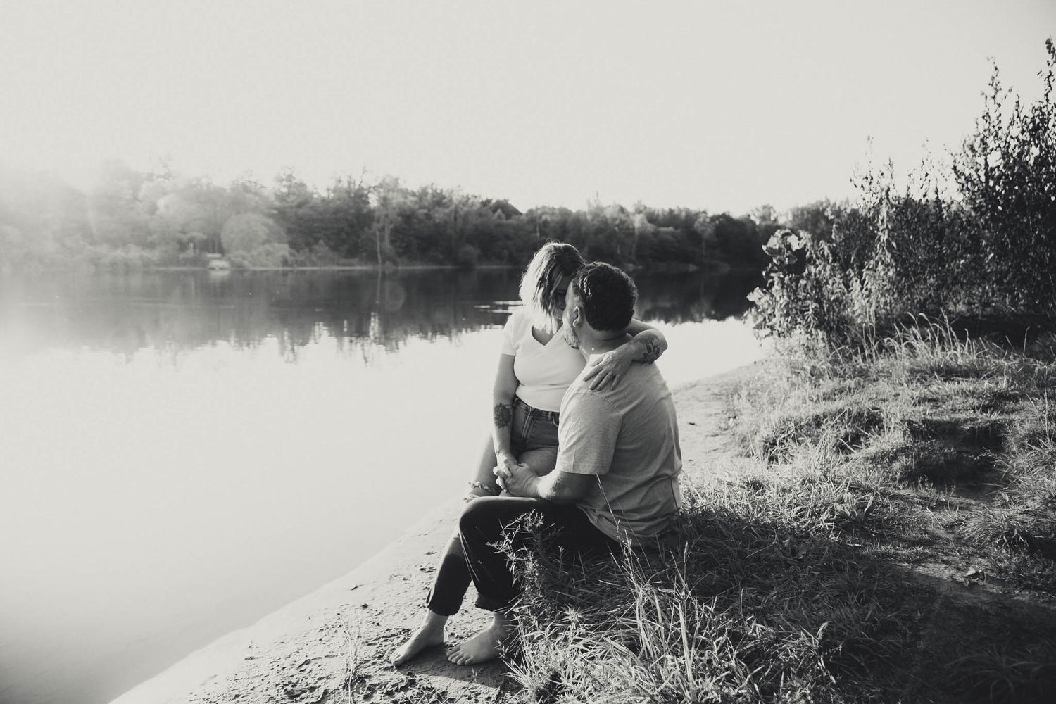 Romantic lakeside maternity photography session at sunset.