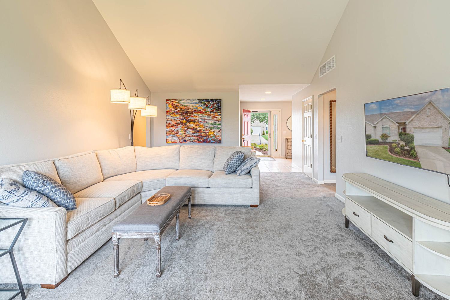 Large carpeted bonus room with white walls and multiple windows for natural lighting.
