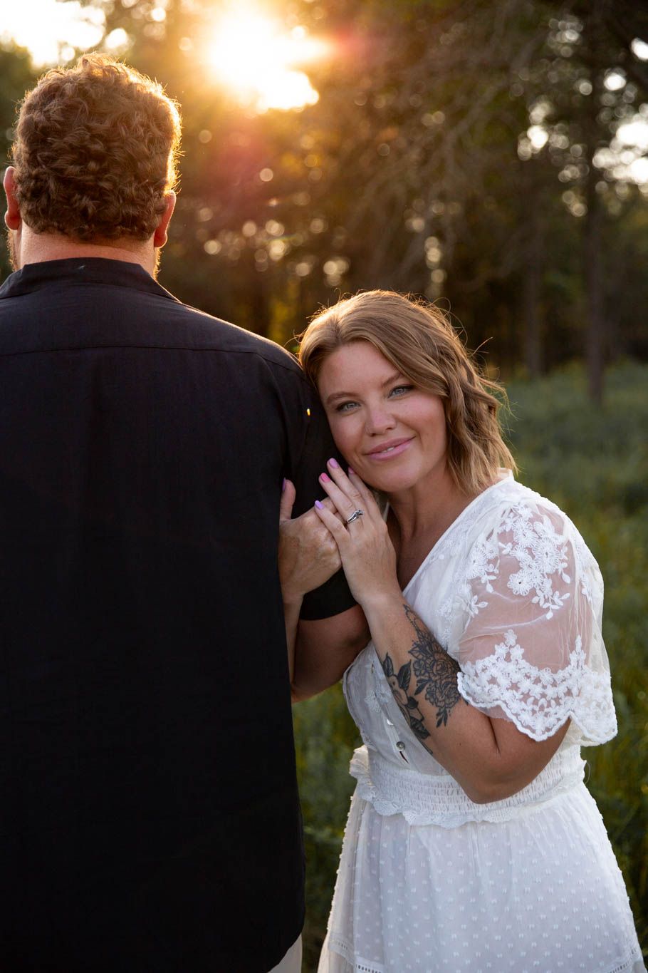 Romantic sunset wedding photos of couple embracing in golden hour light.