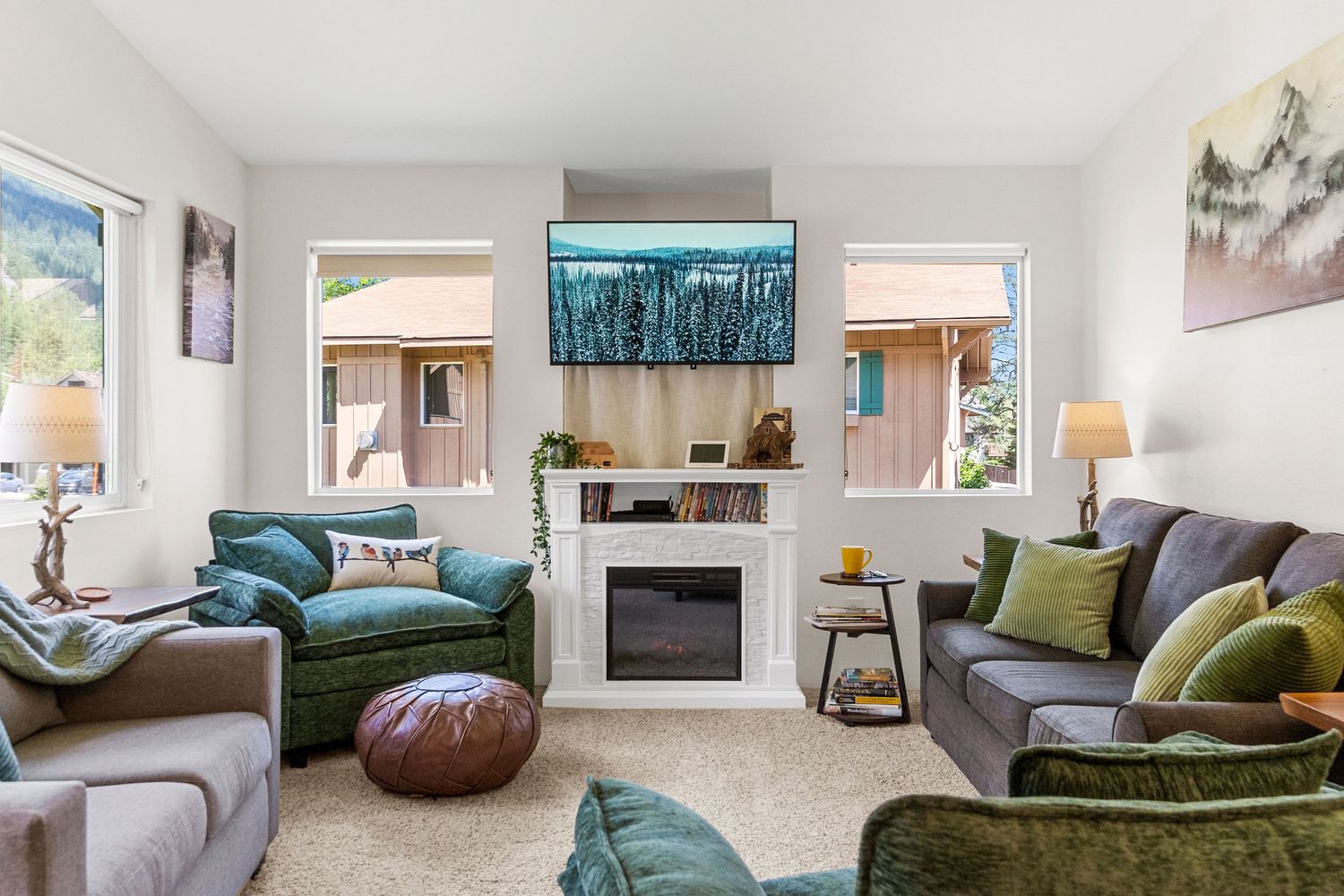 Spacious living room with fireplace, comfortable seating, and large windows for natural light.