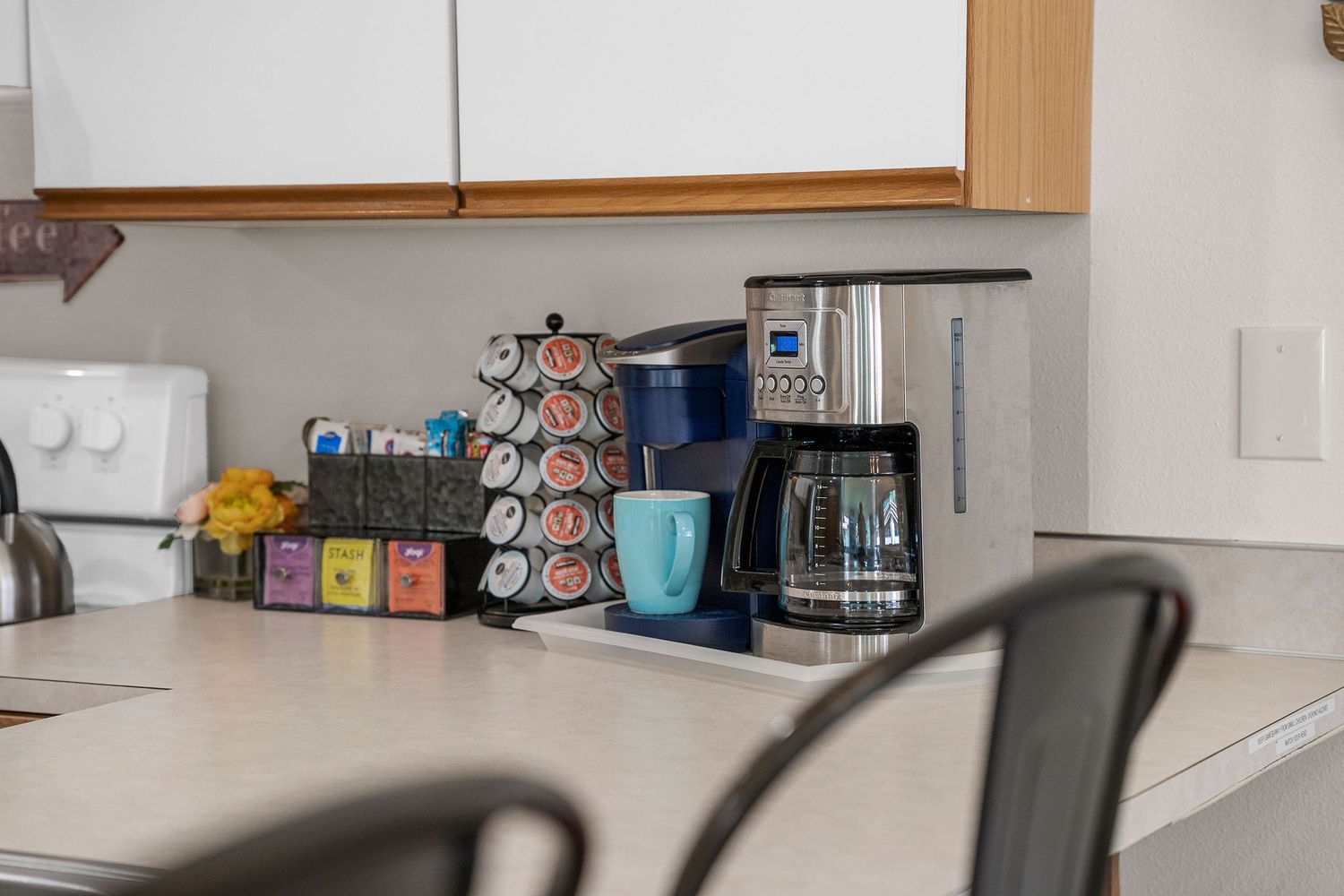 Kitchen storage area with white cabinets and assorted food items on display.