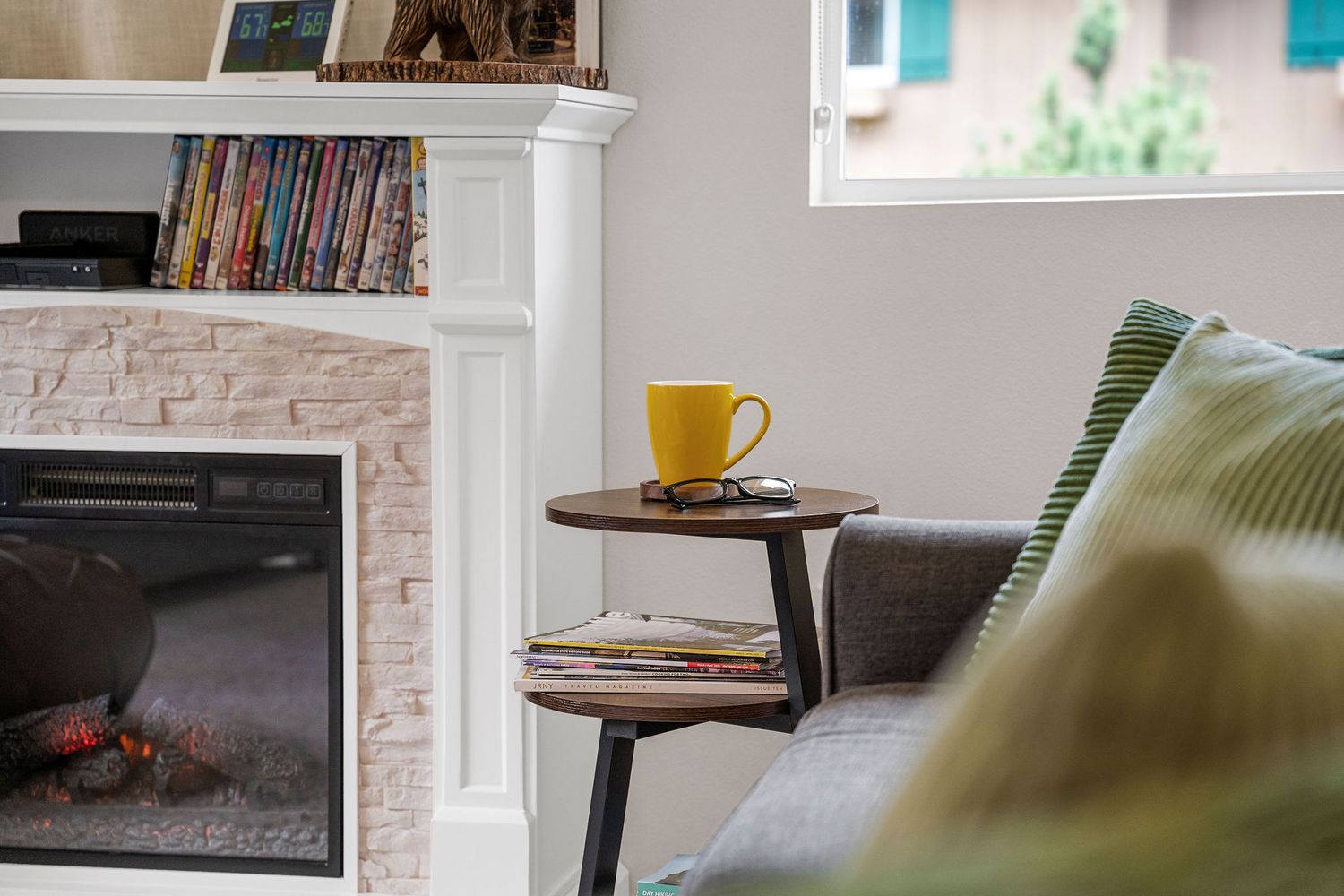 Living area with stone fireplace, bookshelves, and comfortable seating arrangements.