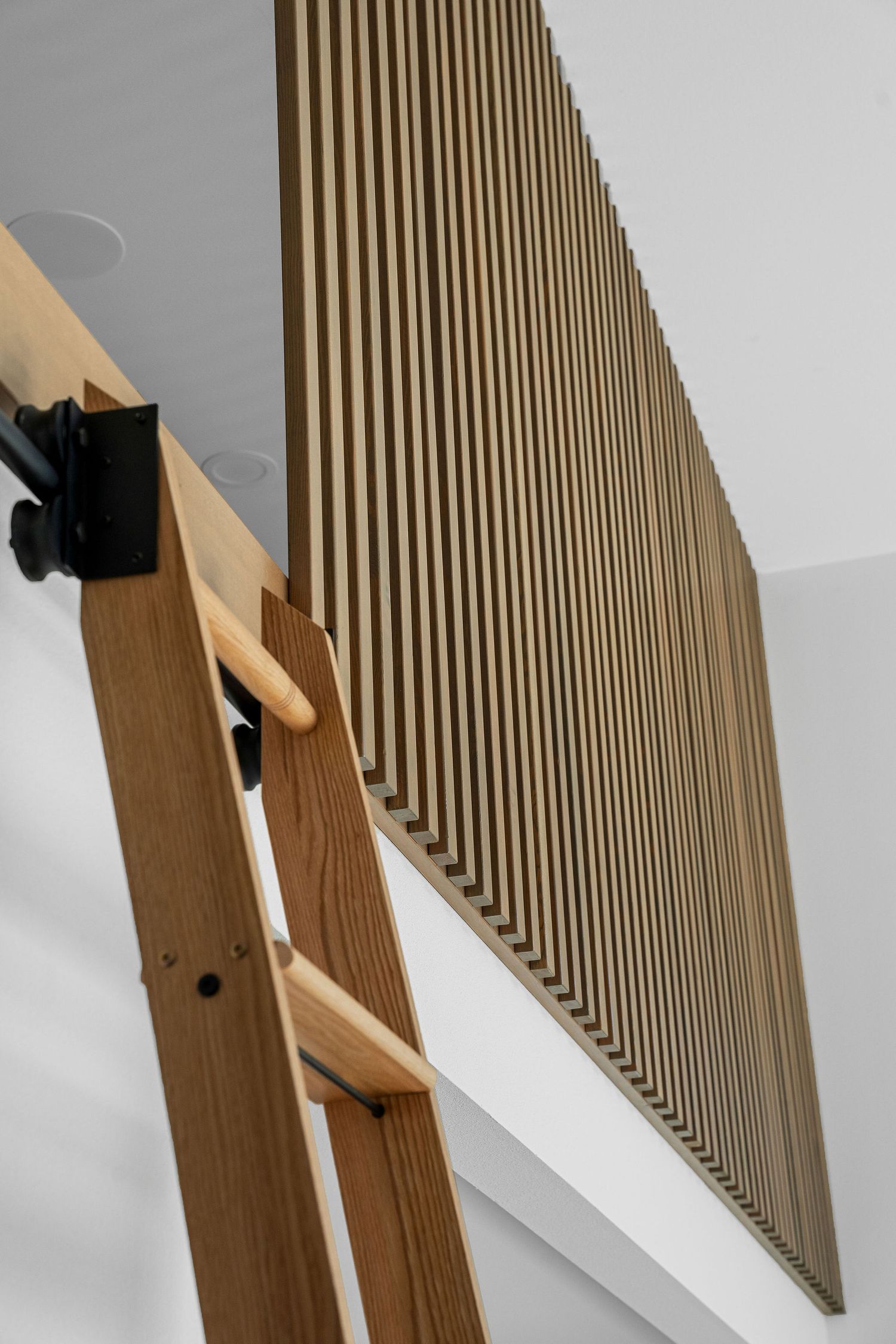 Close-up of vertical wooden slats mounted on a wall creating a modern slatted accent feature.