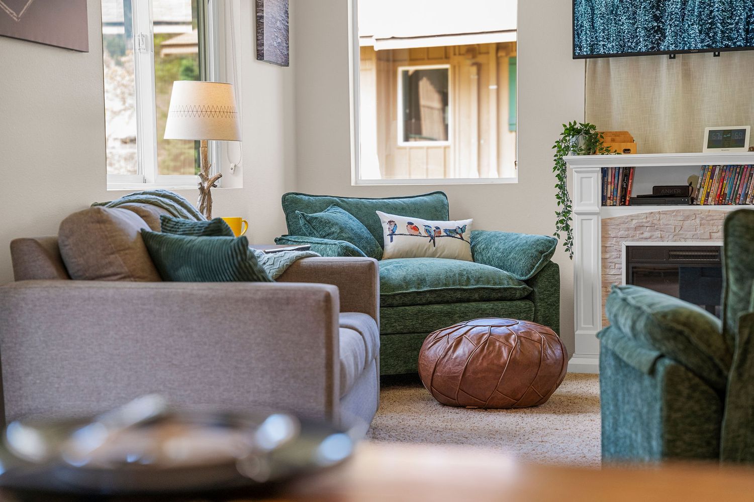 Contemporary living space featuring teal accents and comfortable seating areas.