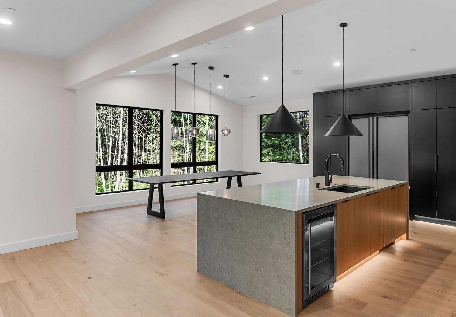 Spacious open floor plan interior with modern kitchen and living areas bathed in natural light.