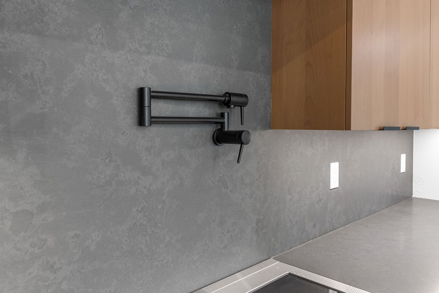 Modern bathroom featuring sleek gray walls, recessed lighting, and contemporary fixtures in a minimalist design.