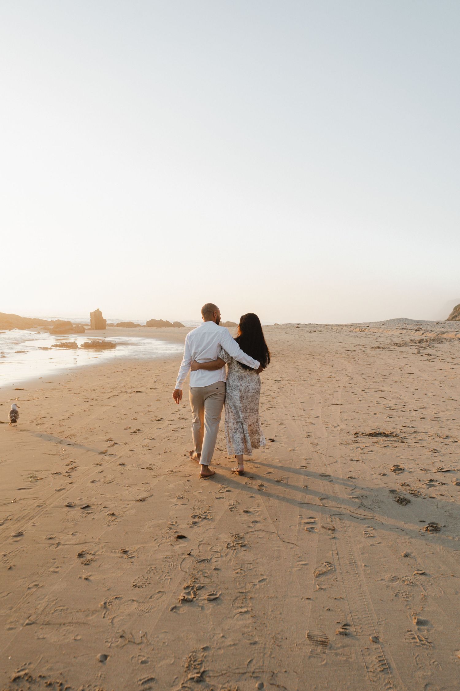 Engagement picture of a couple at the beach on a Sunset