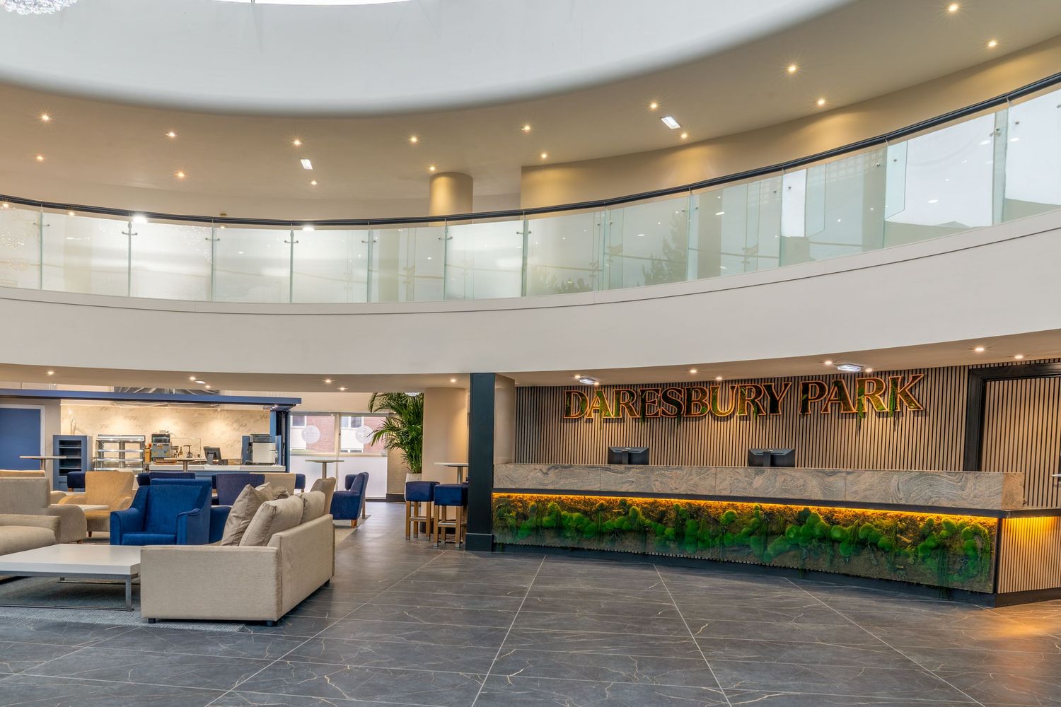 Modern office lobby with curved walls, recessed lighting, and sleek minimalist furniture creates an elegant corporate atmosphere.