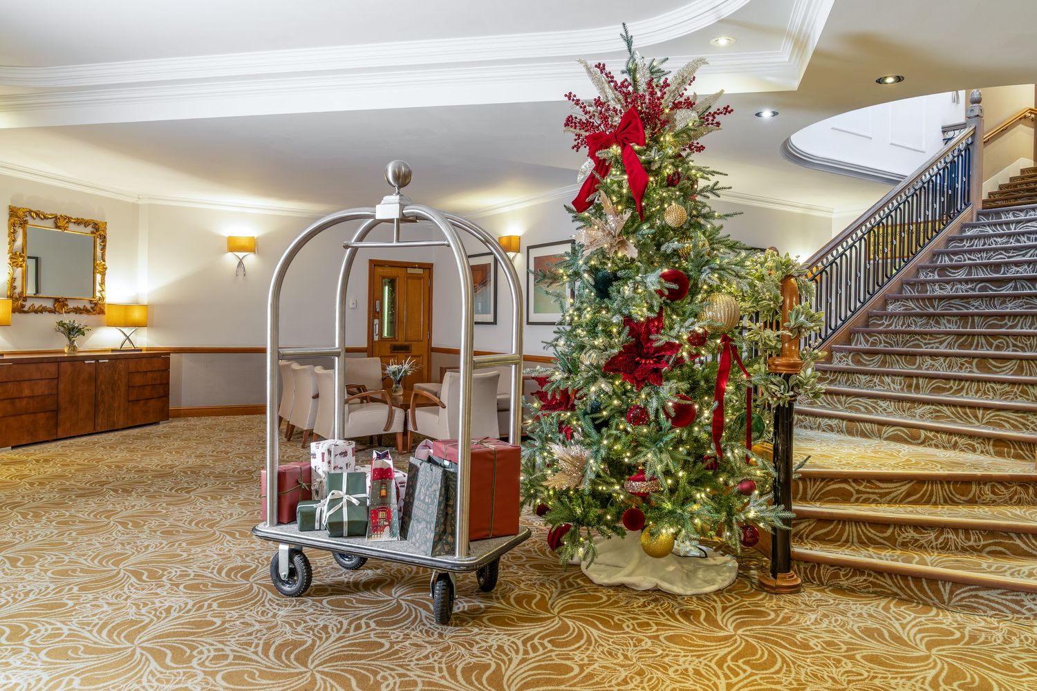 A collage of luxury hotel interior spaces showing grand staircases, elegant decor, and festive holiday decorations.