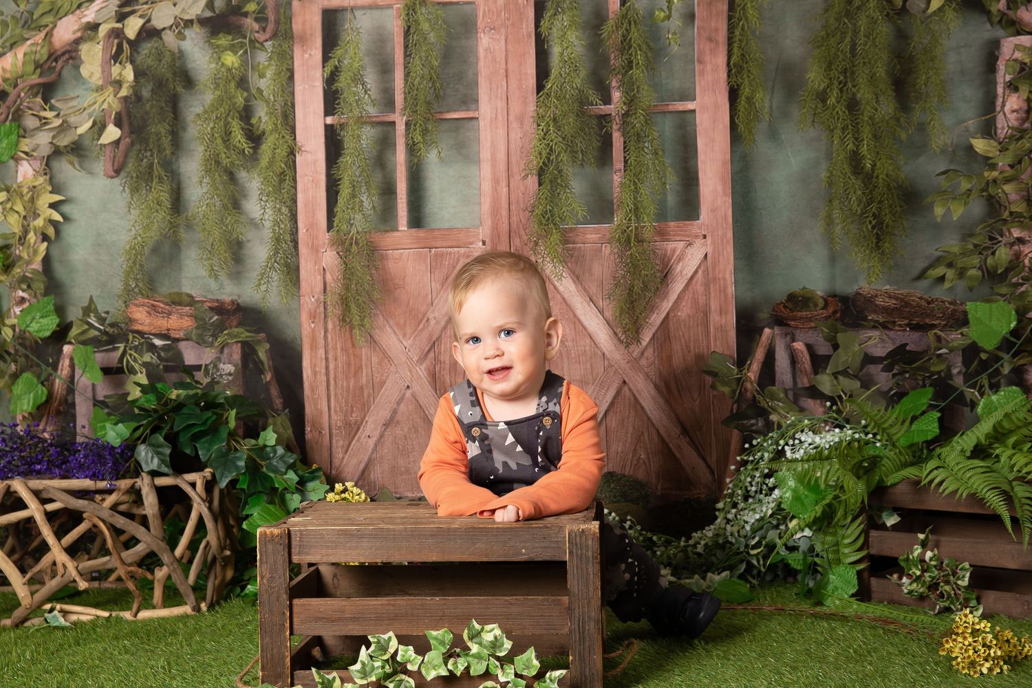 A collection of vintage style outdoor photo backdrops with rustic wooden doors, windows, and greenery creates fairytale scenes.