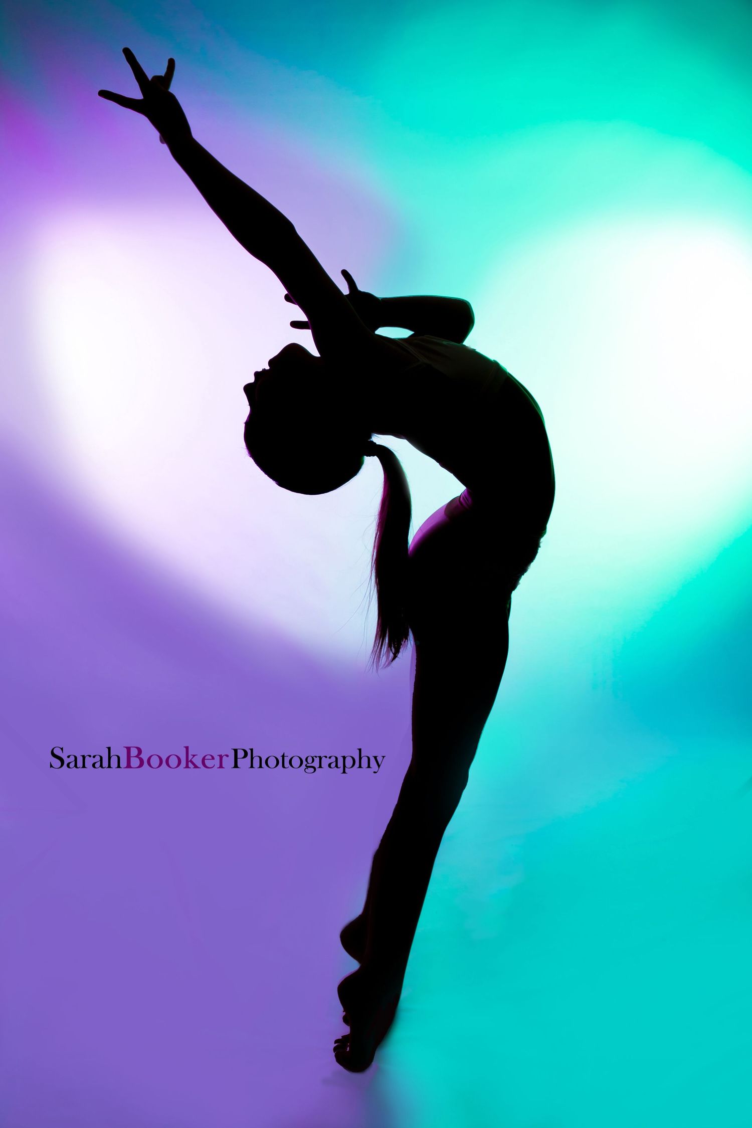 Silhouette of a dancer in an elegant backbend pose against a vibrant turquoise and purple background.