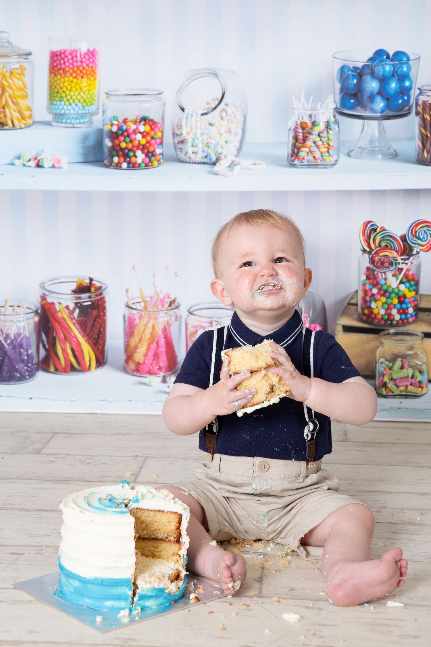 A cake smash photo session progression showing a small child enjoying and making a mess with a blue birthday cake.