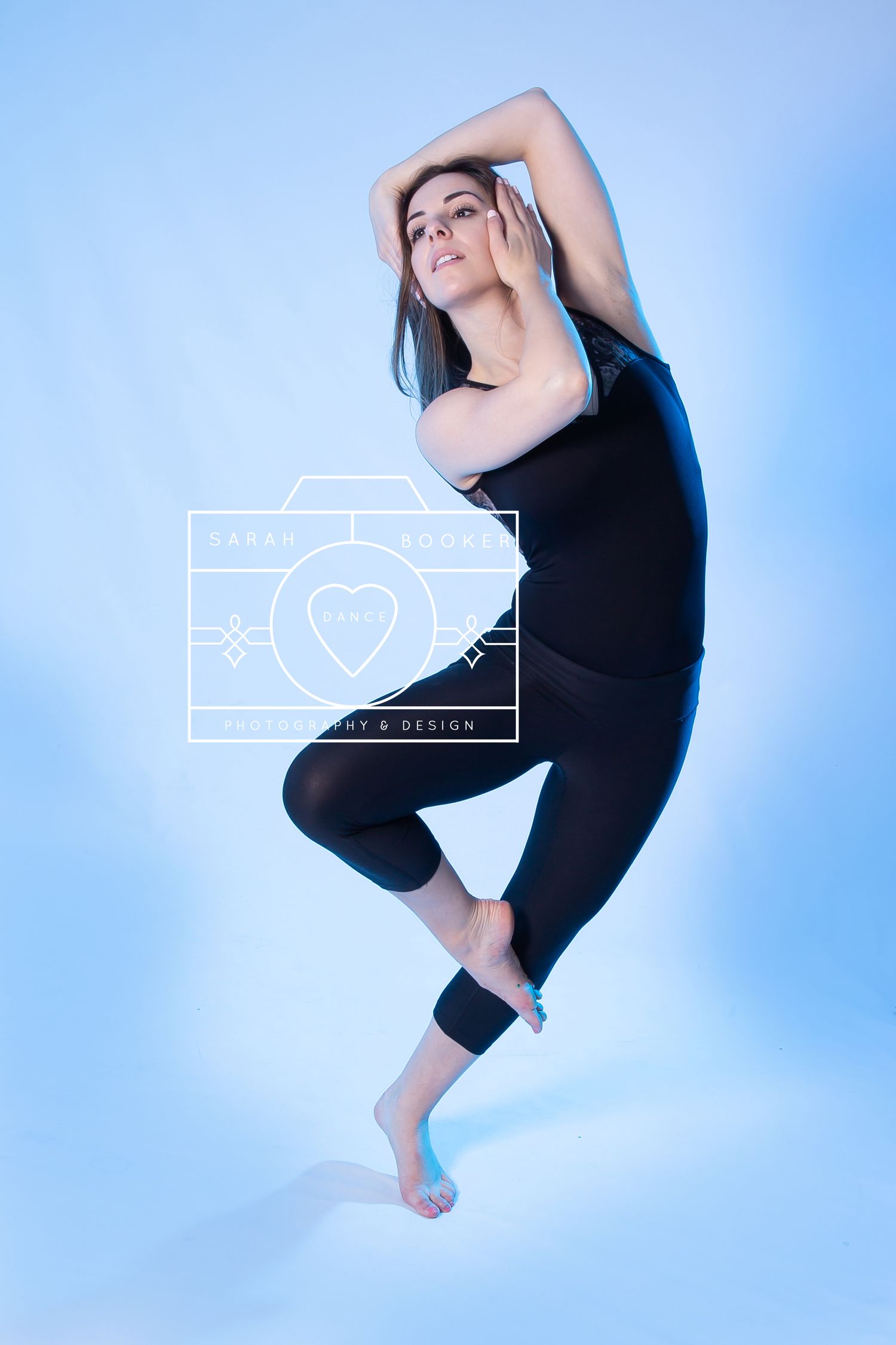 Athletic dancer in black activewear performs modern dance pose against blue background with heart icon overlay.