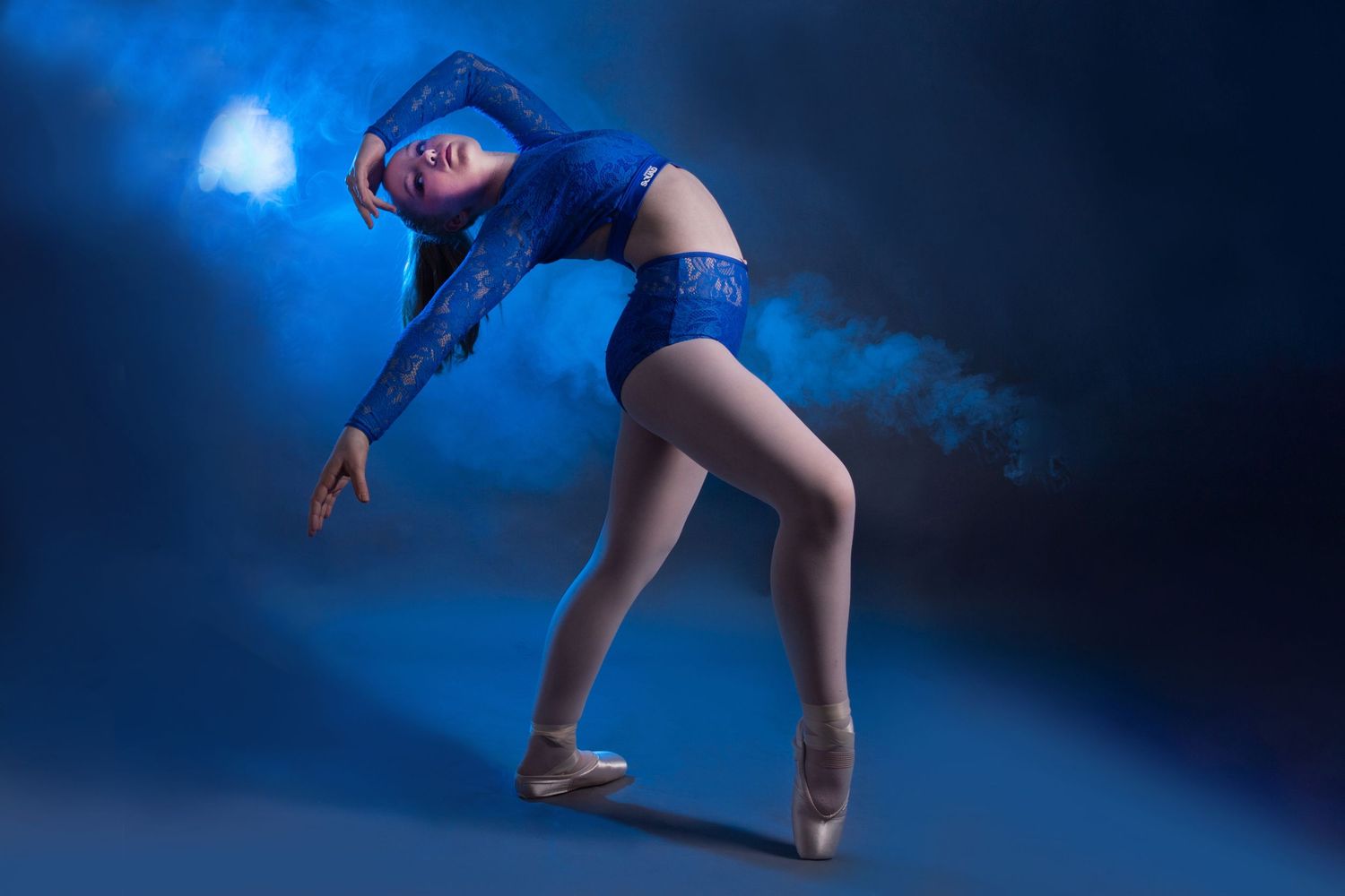 Sequence of dance movements showing graceful poses against a dramatic blue background.