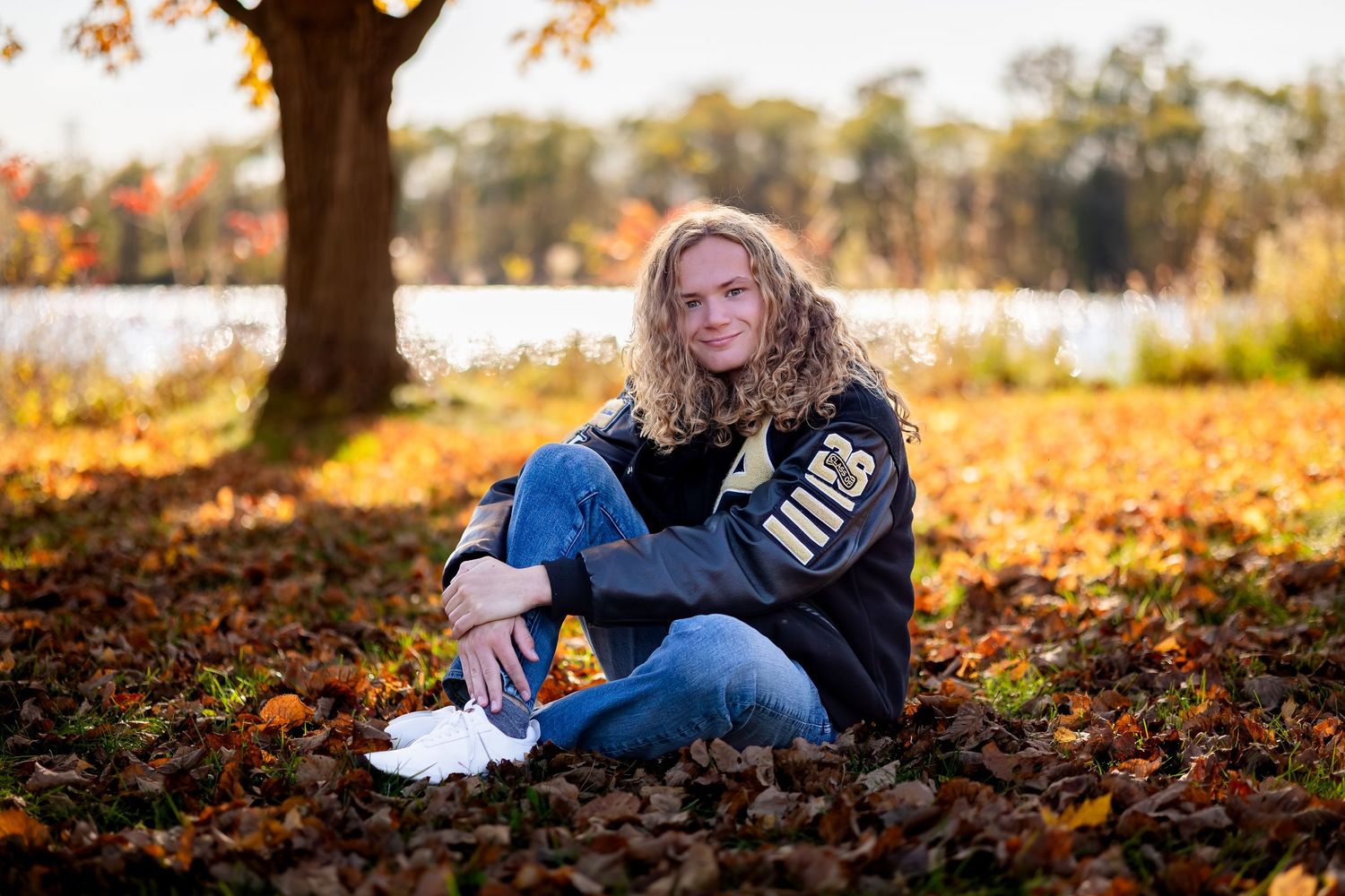 A series of autumn outdoor photos showing someone sitting in fallen leaves during golden hour sunlight.
