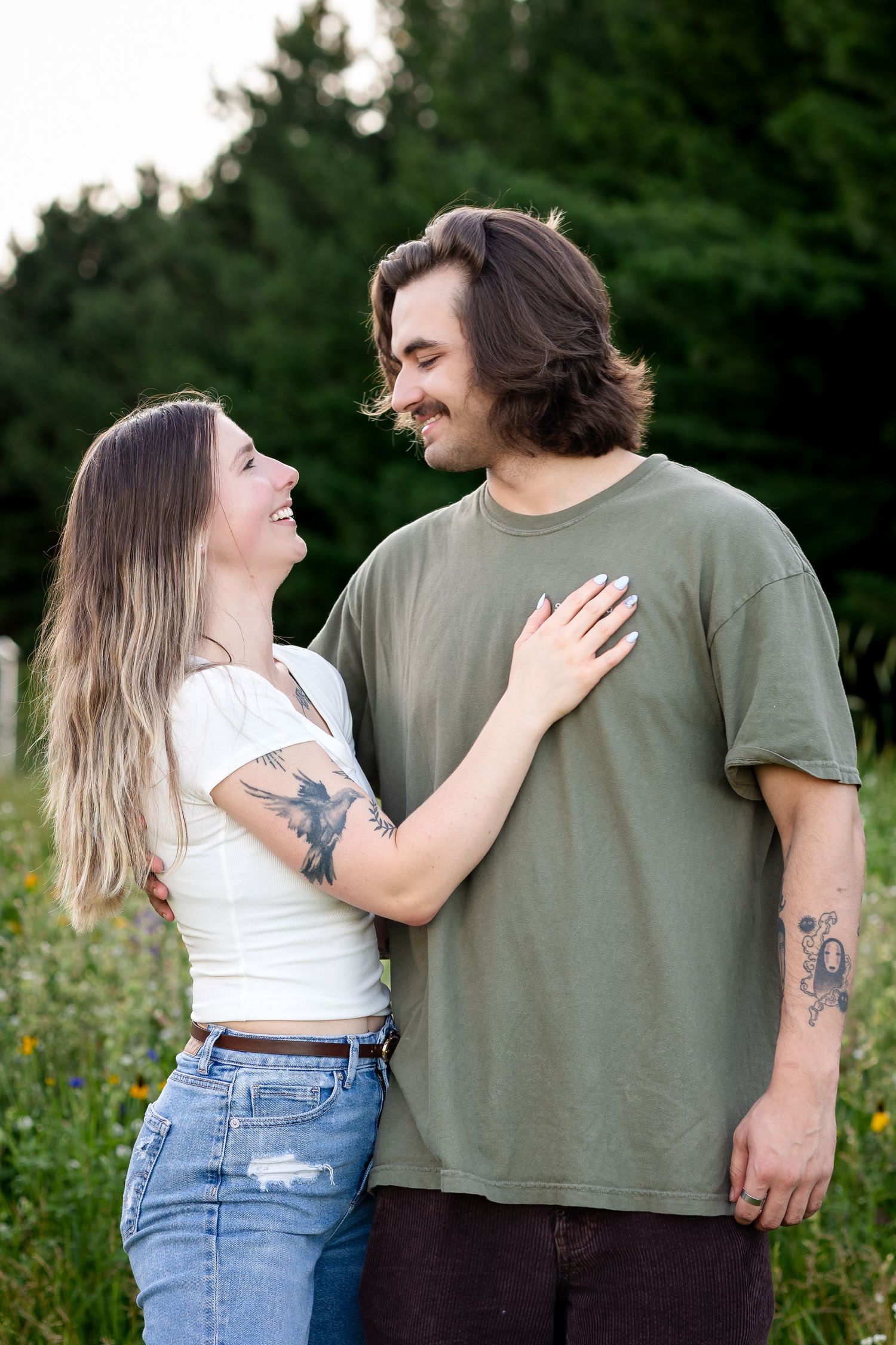 Romantic couple sharing intimate moments in a blooming wildflower field.