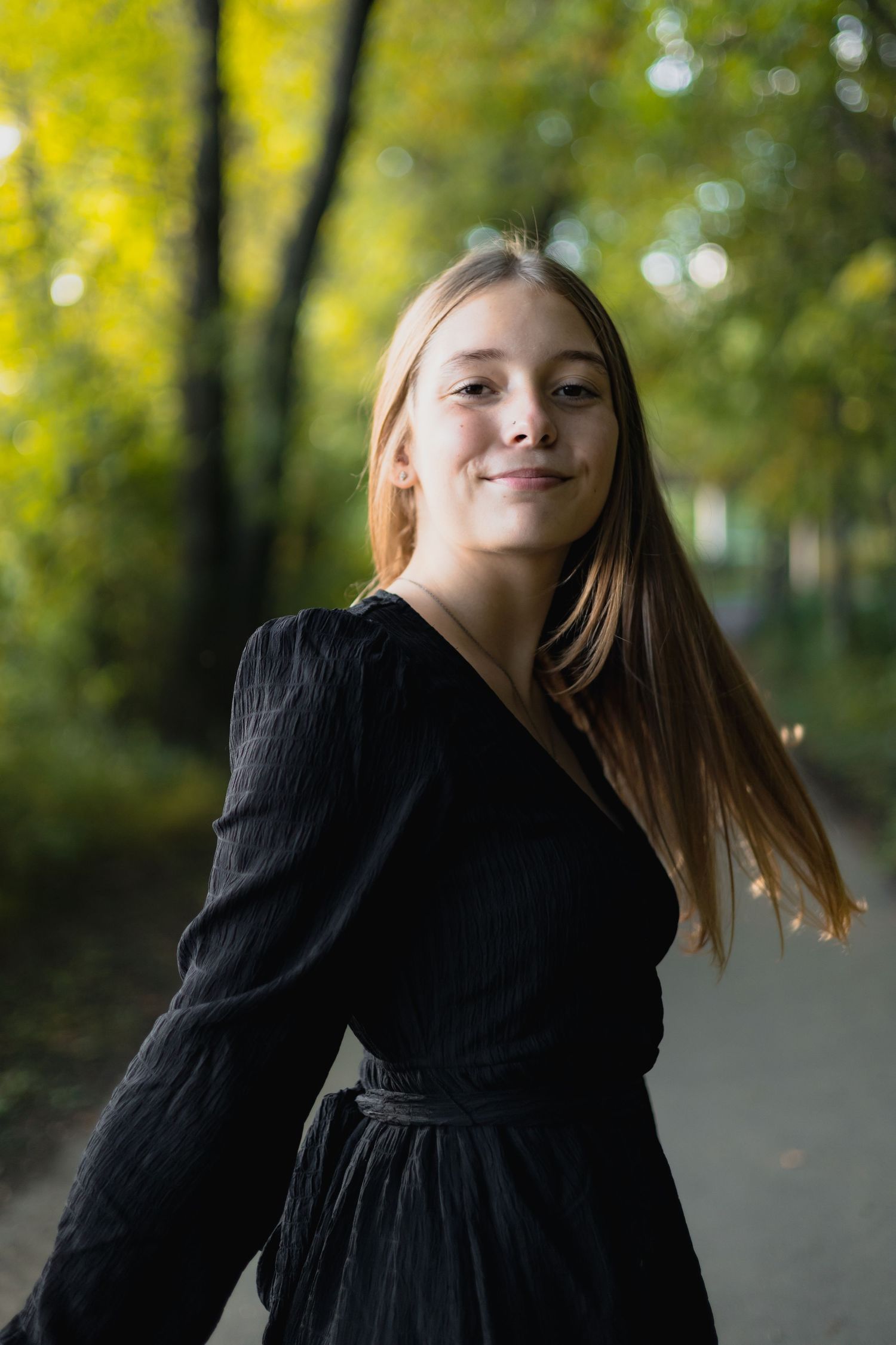 Dynamic portrait series showing movement in black dress against autumn foliage.
