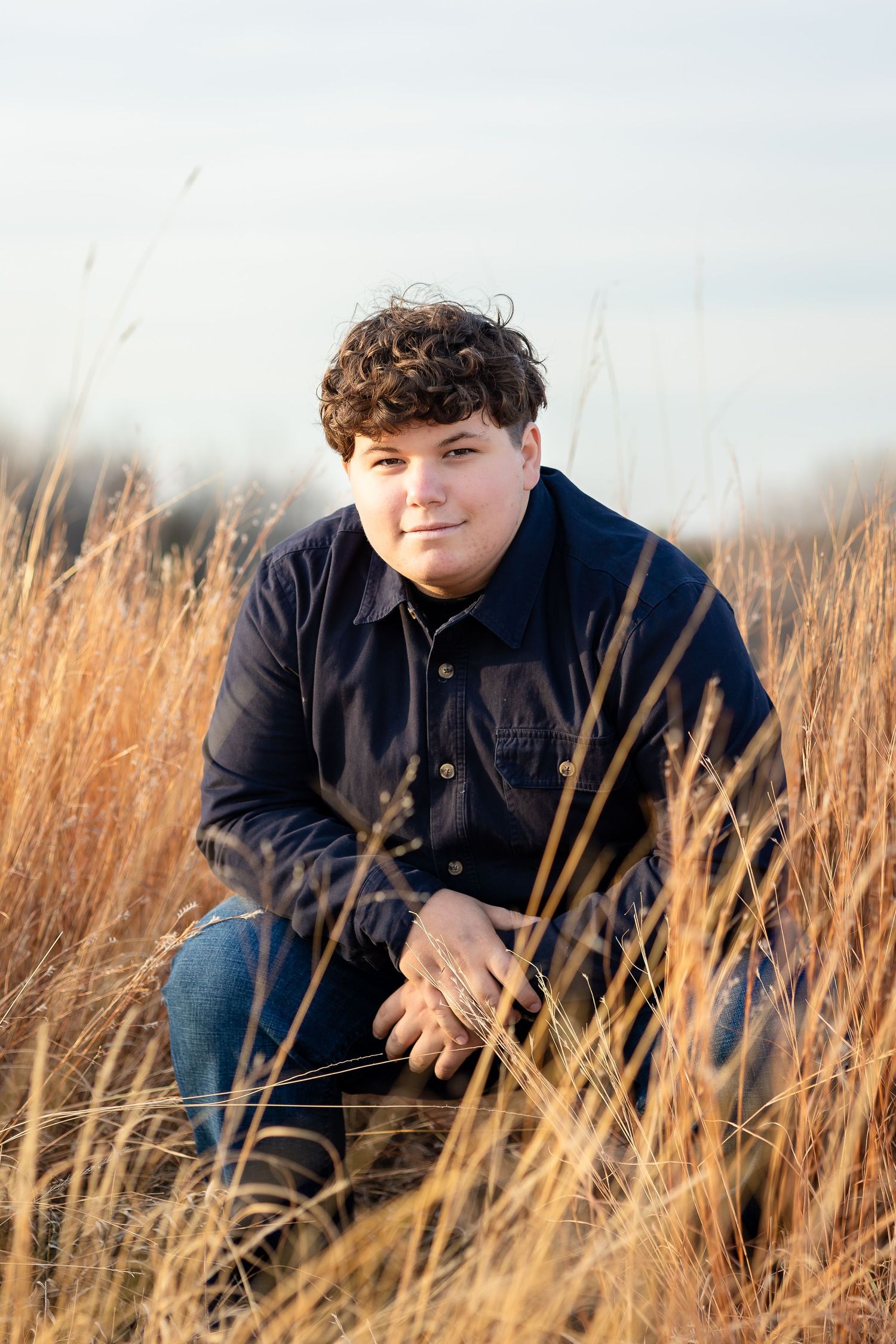Portrait among tall prairie grass during golden hour.