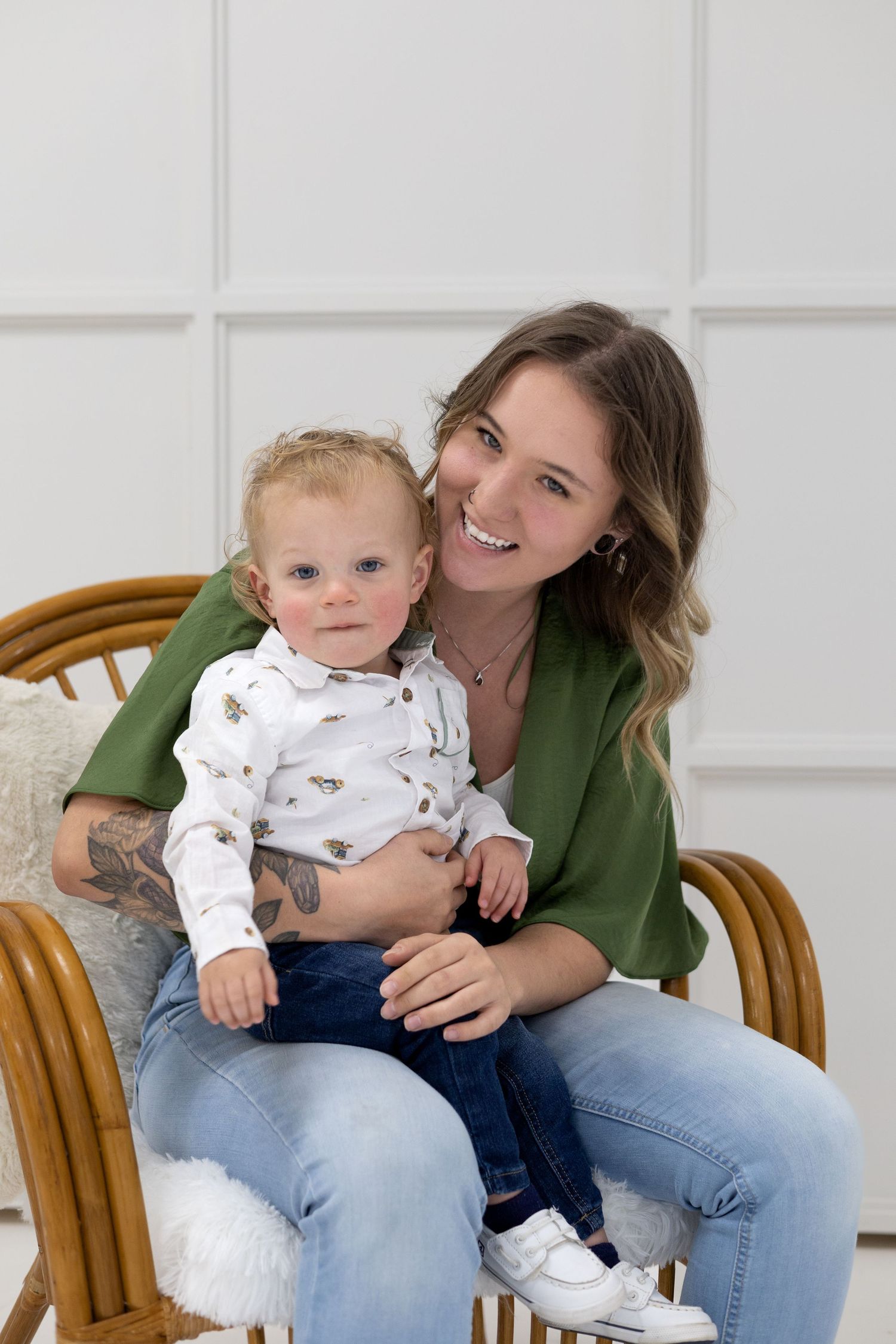 A bright indoor portrait session featuring casual style and natural smiles in a white room.