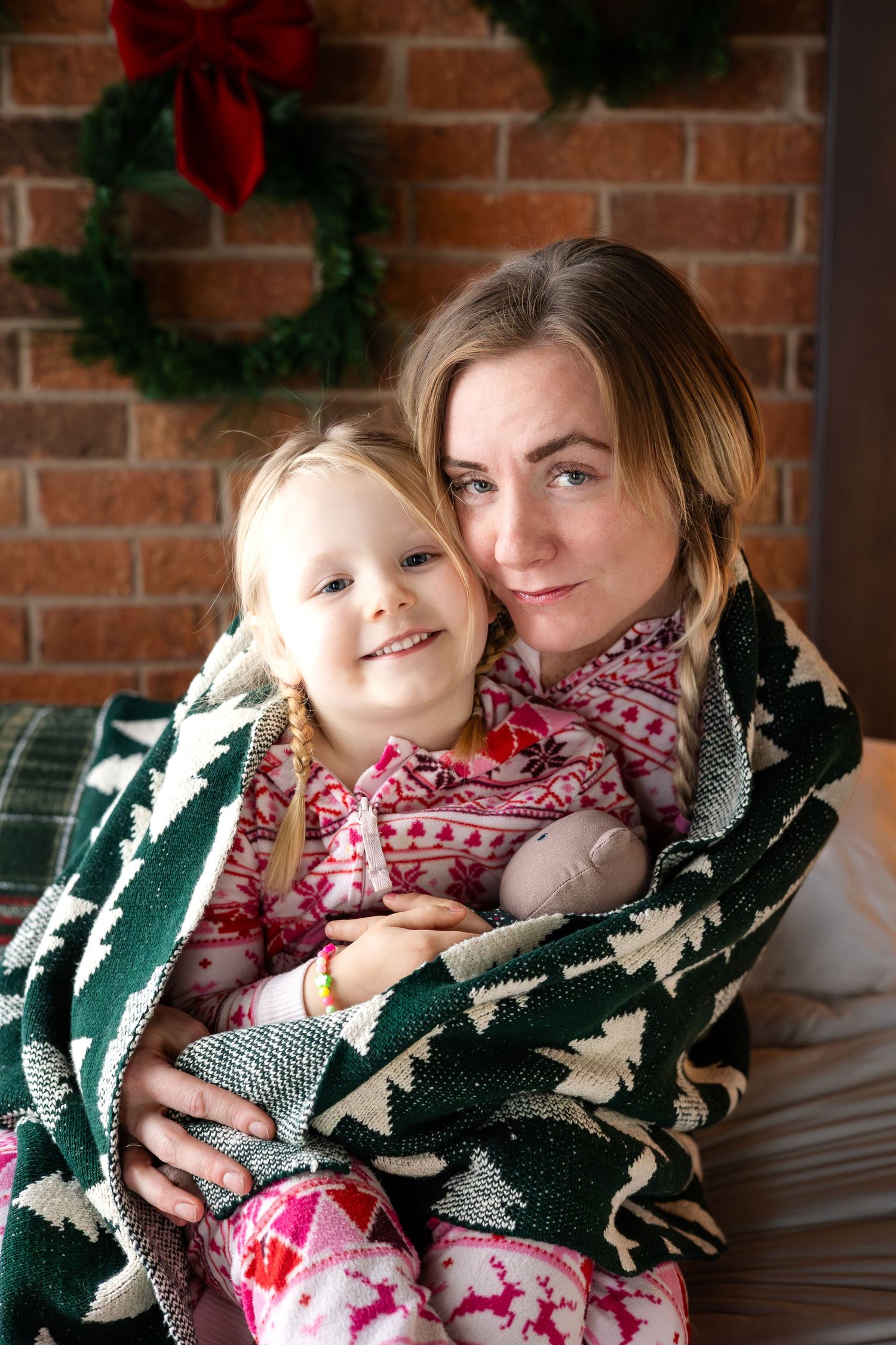 Holiday scene with Christmas wreaths and a cozy green knit blanket.