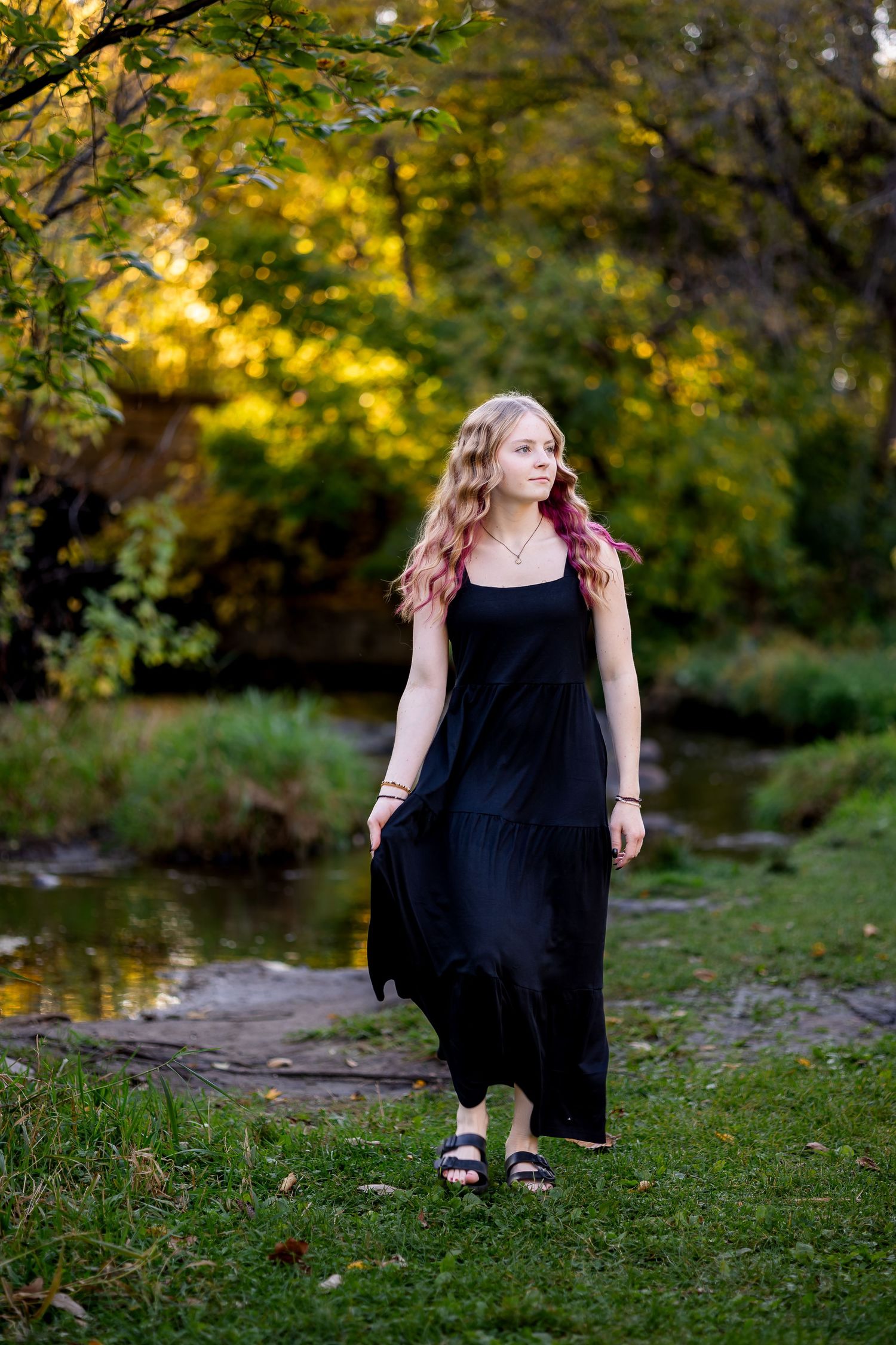 Artistic outdoor photo sequence showing movement and poses against autumn scenery with grass and trees.