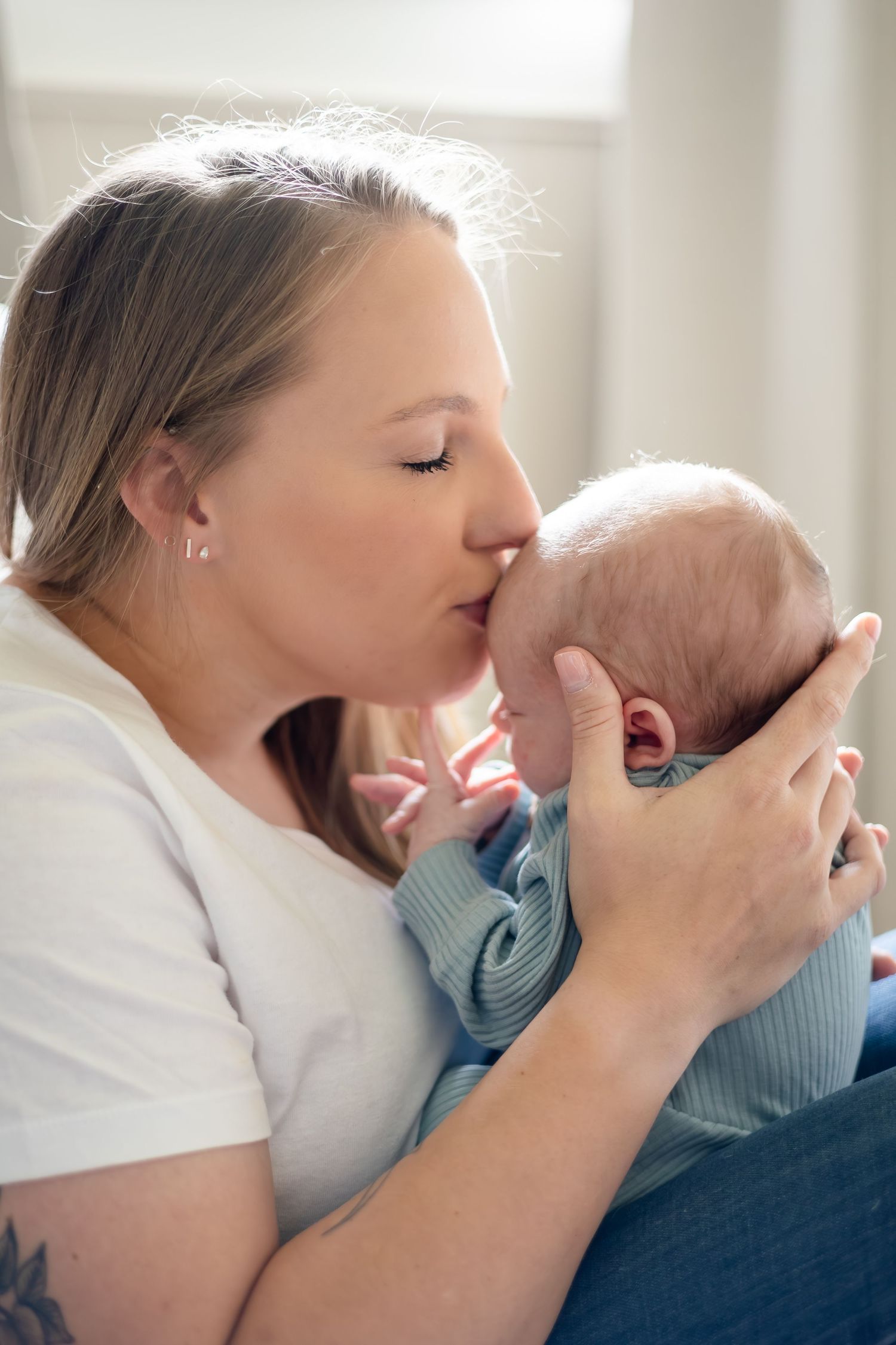 Tender moment between parent and baby during an intimate photo session.