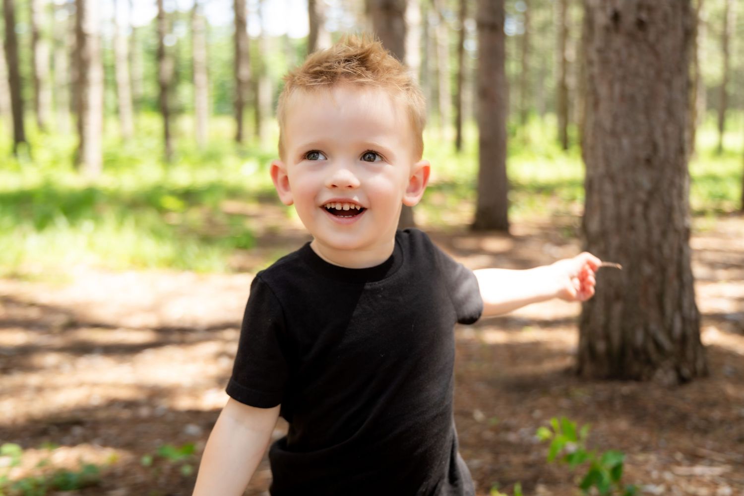 Candid expressions and smiles photographed in a forest setting.