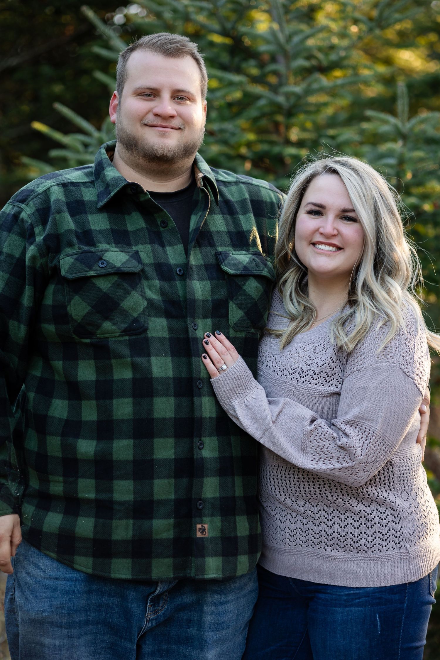 A couple in coordinated casual outfits sharing loving moments during an outdoor photo session.