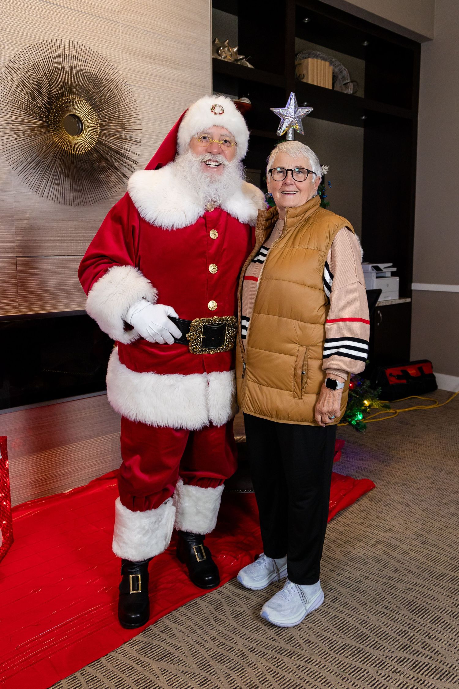 Christmas themed photo area with red carpet and holiday decorations.
