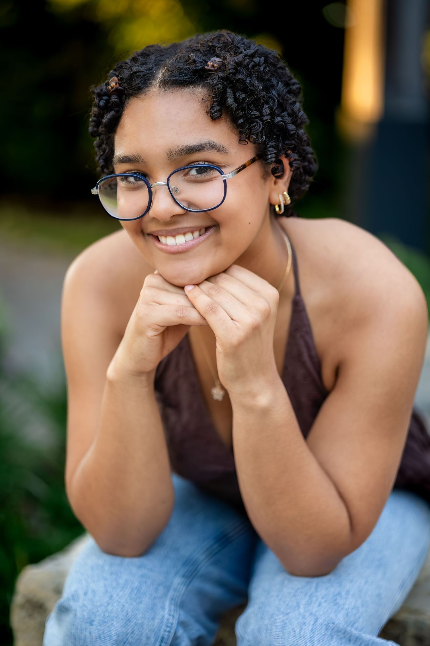 Playful outdoor portrait series showing someone in glasses and casual attire making expressive poses.