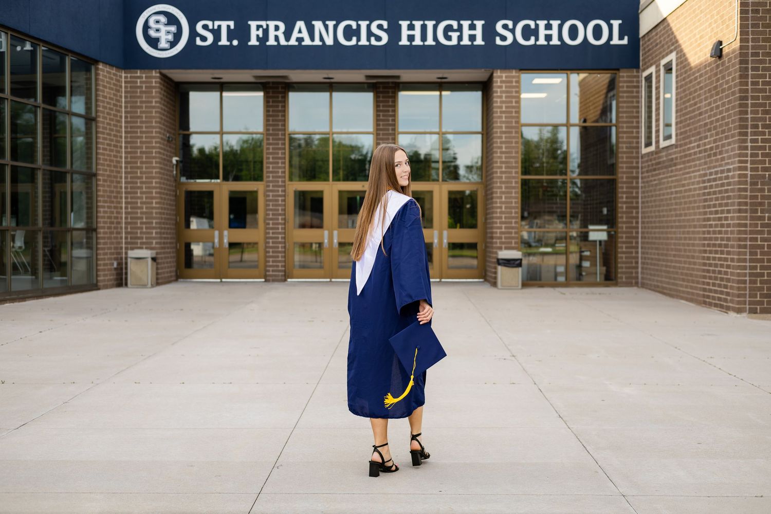 St. Francis High School exterior entrance with brick facade and glass doors.