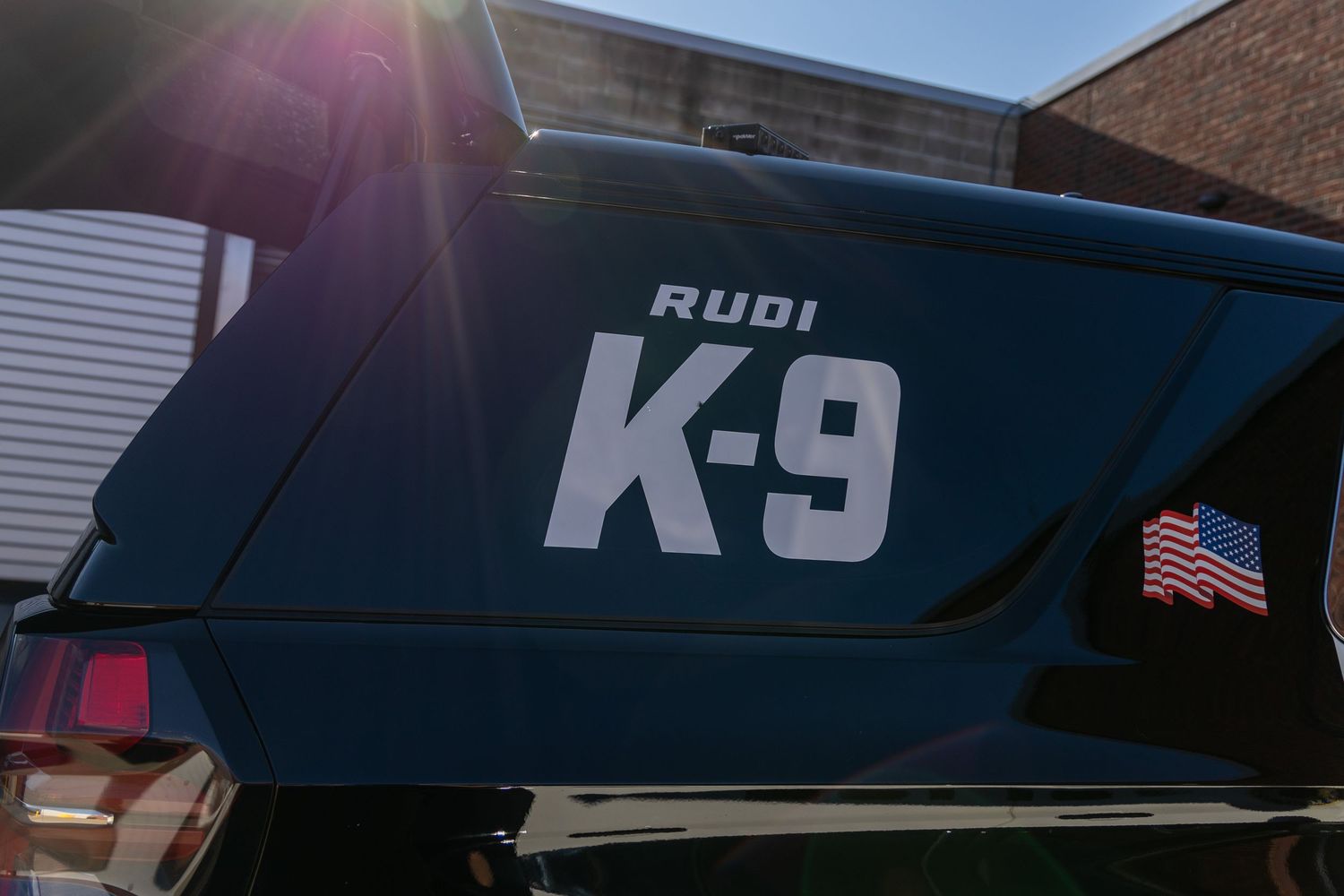 Police K-9 unit vehicle markings with American flag detail.