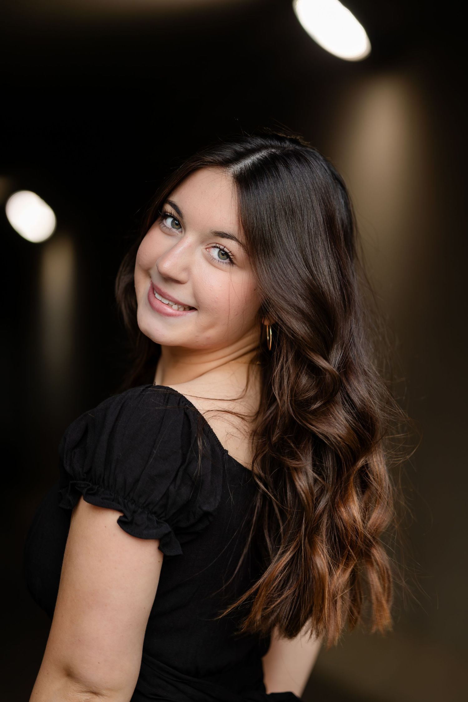 Portrait series showing playful expressions in dark indoor setting.