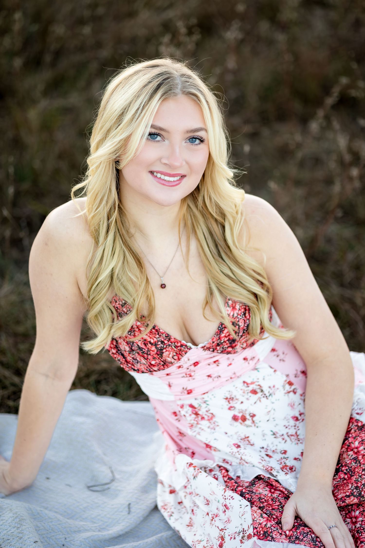 A series of outdoor portrait photos showing someone in a red and white floral dress against a natural background.